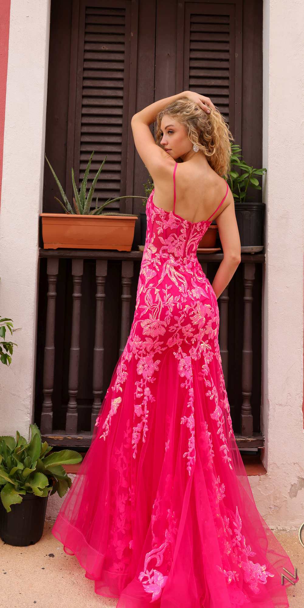 Coral pink sequin applique trumpet gown with open back straps and flared skirt