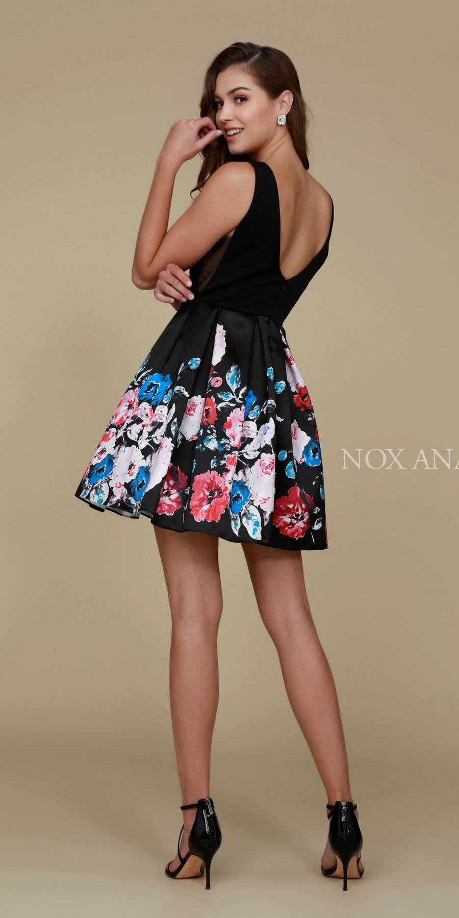 Floral print skater dress with black sleeveless top and colorful mid-thigh skirt