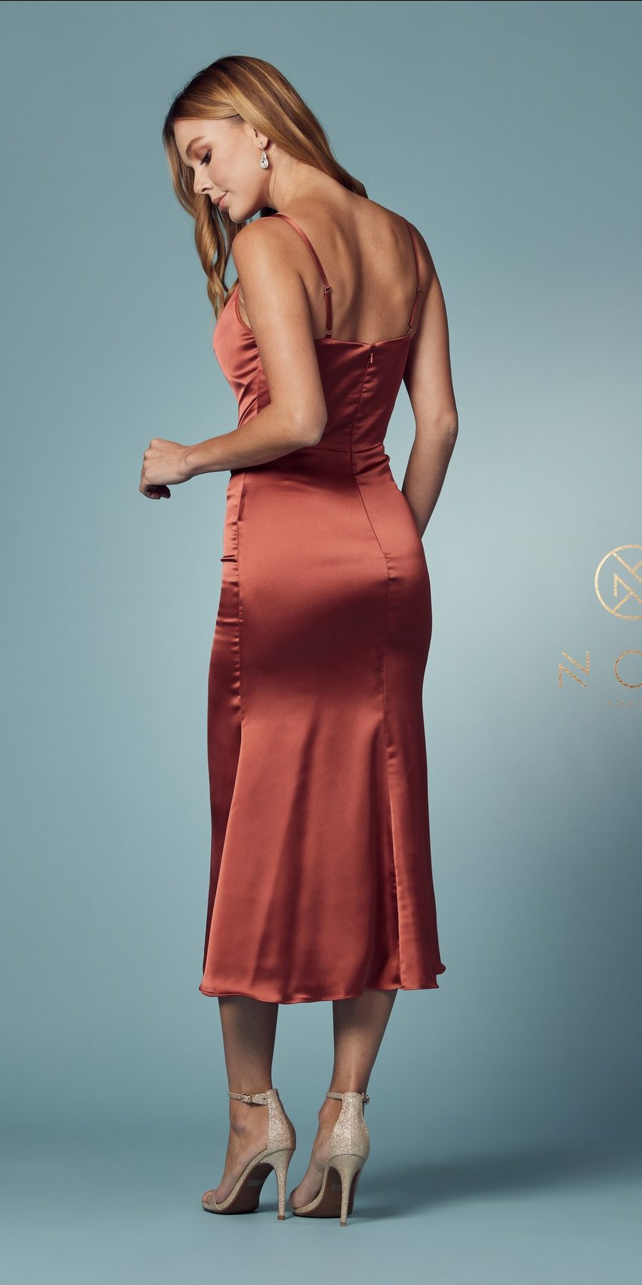 Rust satin midi gown with cowl neckline and thin spaghetti straps, side view