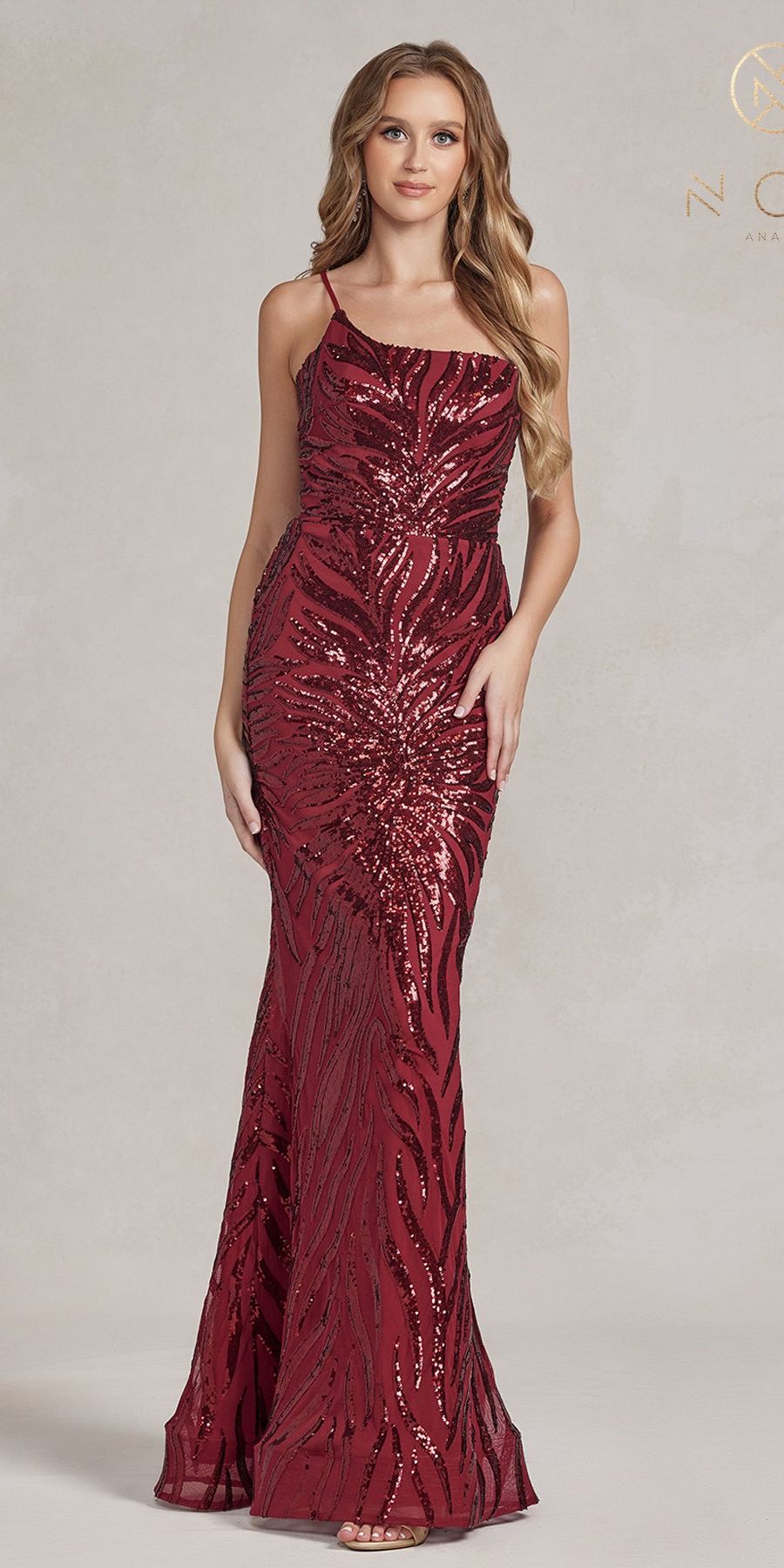 Burgundy fitted sequin evening gown with spaghetti straps and flowing mermaid skirt