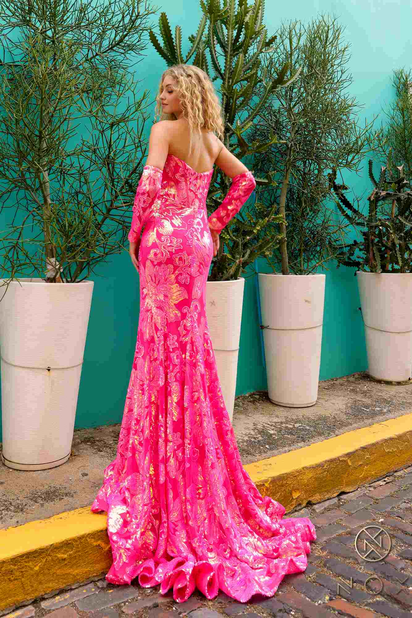 Fuchsia strapless sequin gown with floral pattern and long matching sleeves, open back
