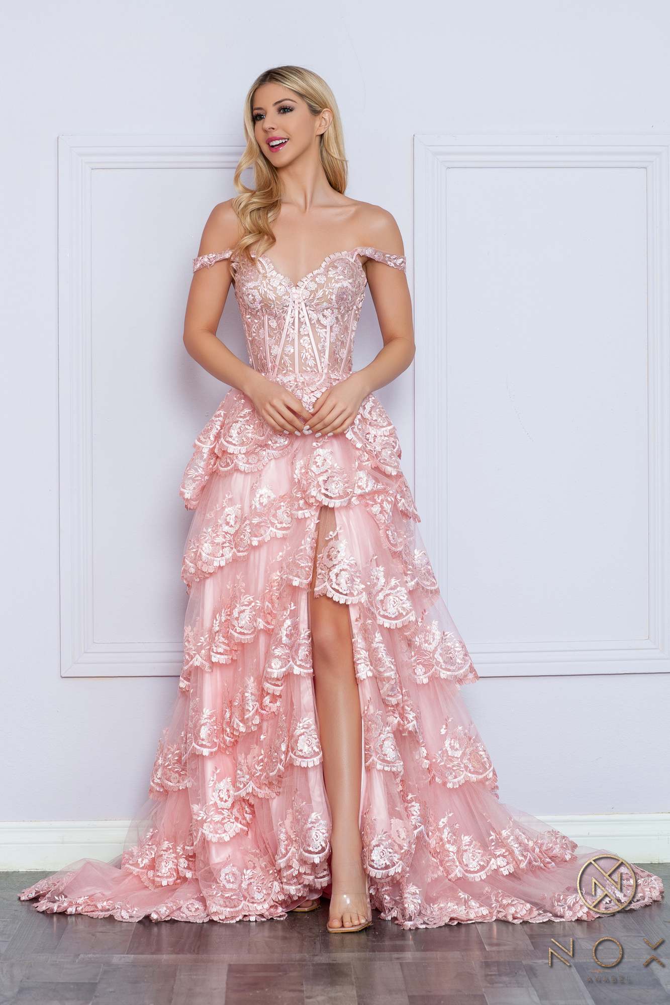 Long off-the-shoulder tiered A-line formal gown in blush pink, front view