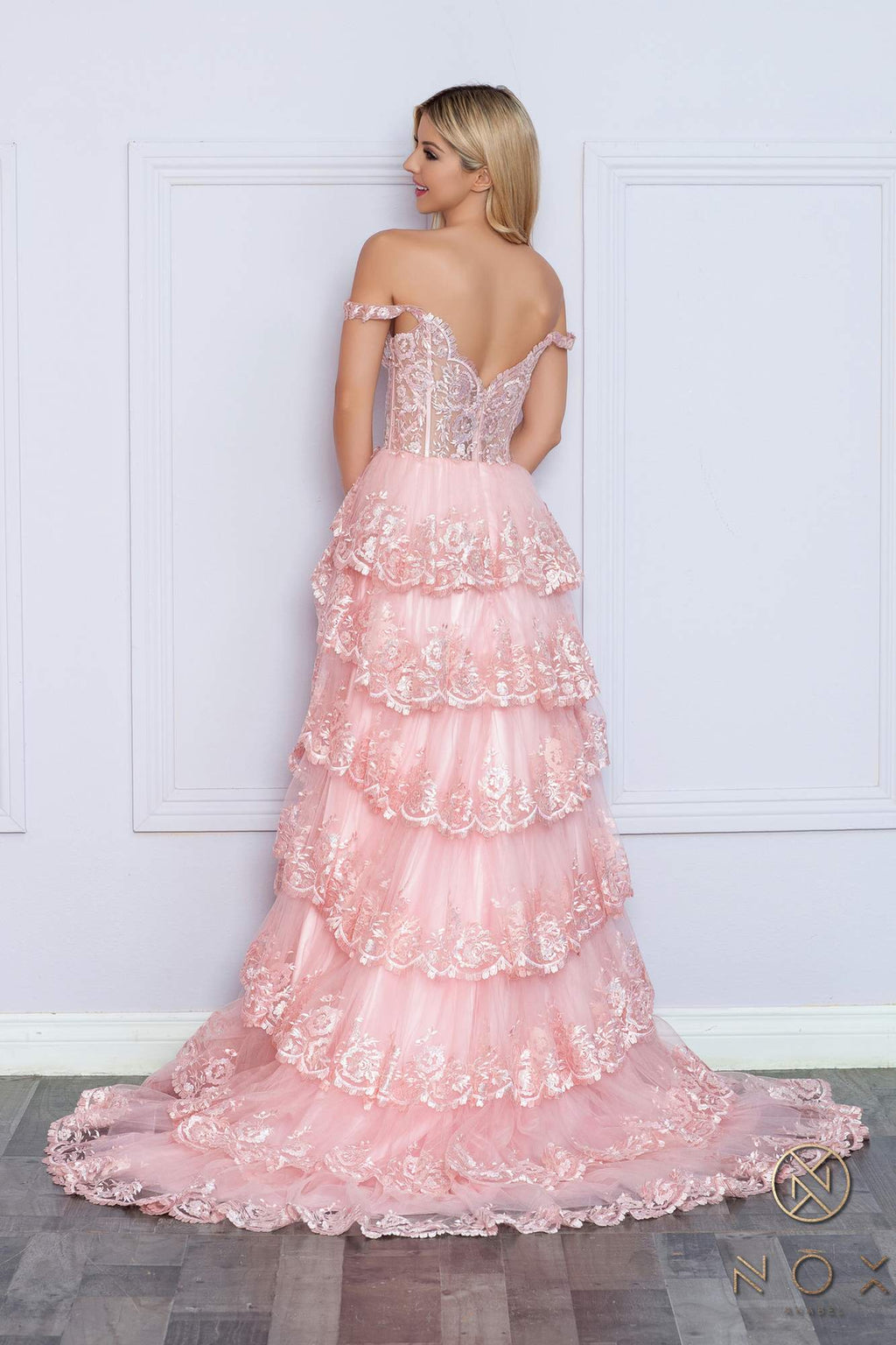 Long off-the-shoulder tiered A-line formal gown in blush pink, back view