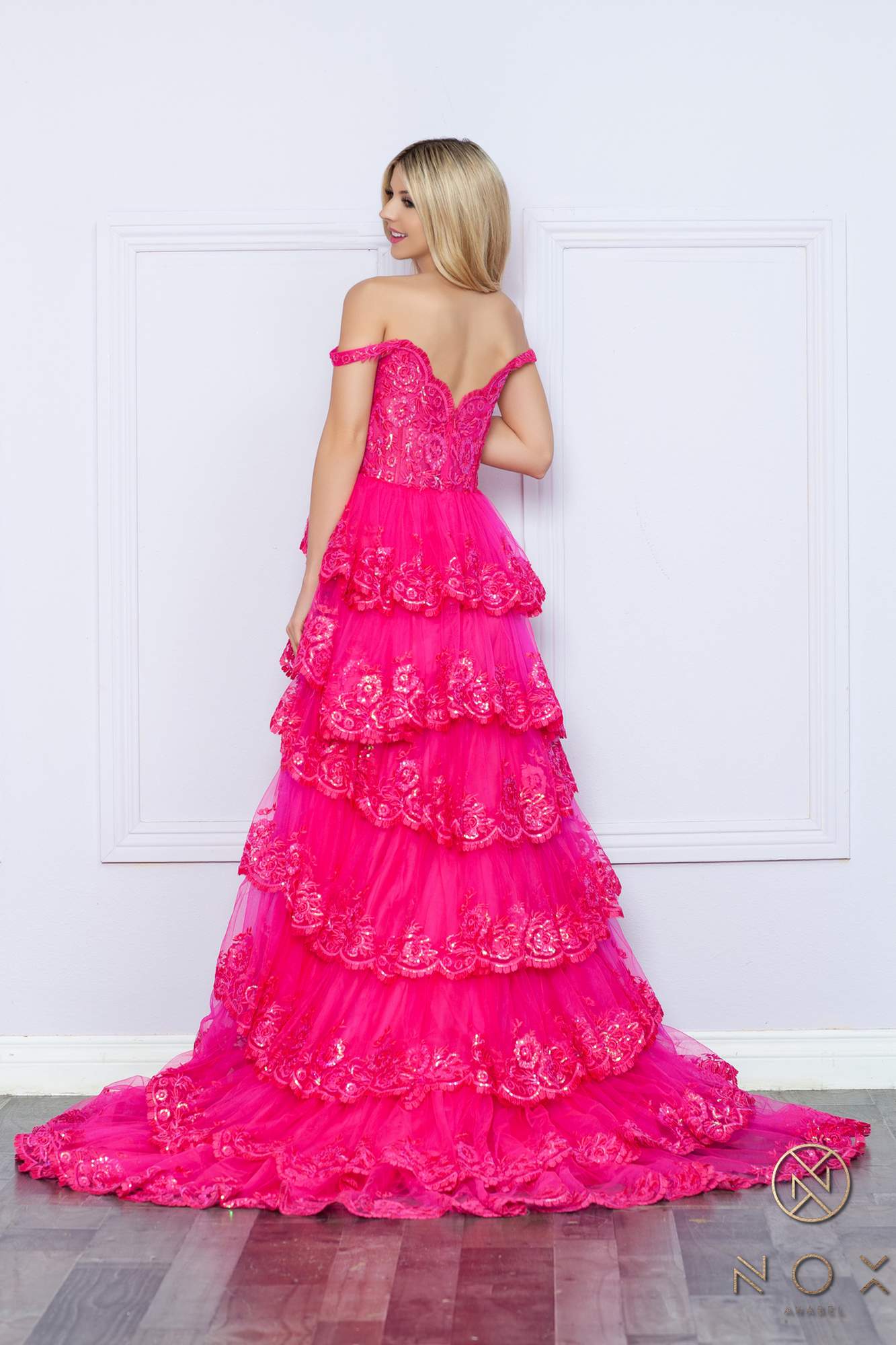 Long off-the-shoulder tiered A-line formal gown in fuchsia pink, back view