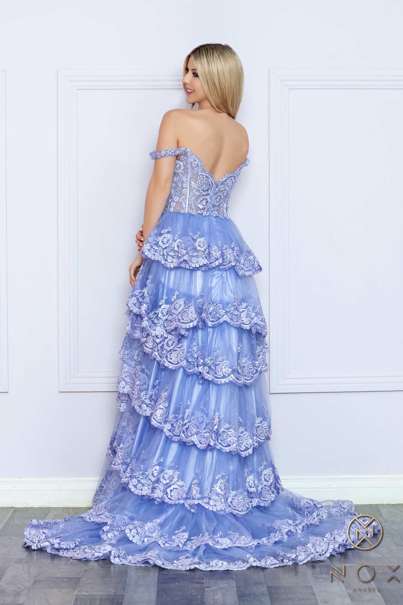 Long off-shoulder tiered A-line formal gown in periwinkle, lace back view and layered skirt