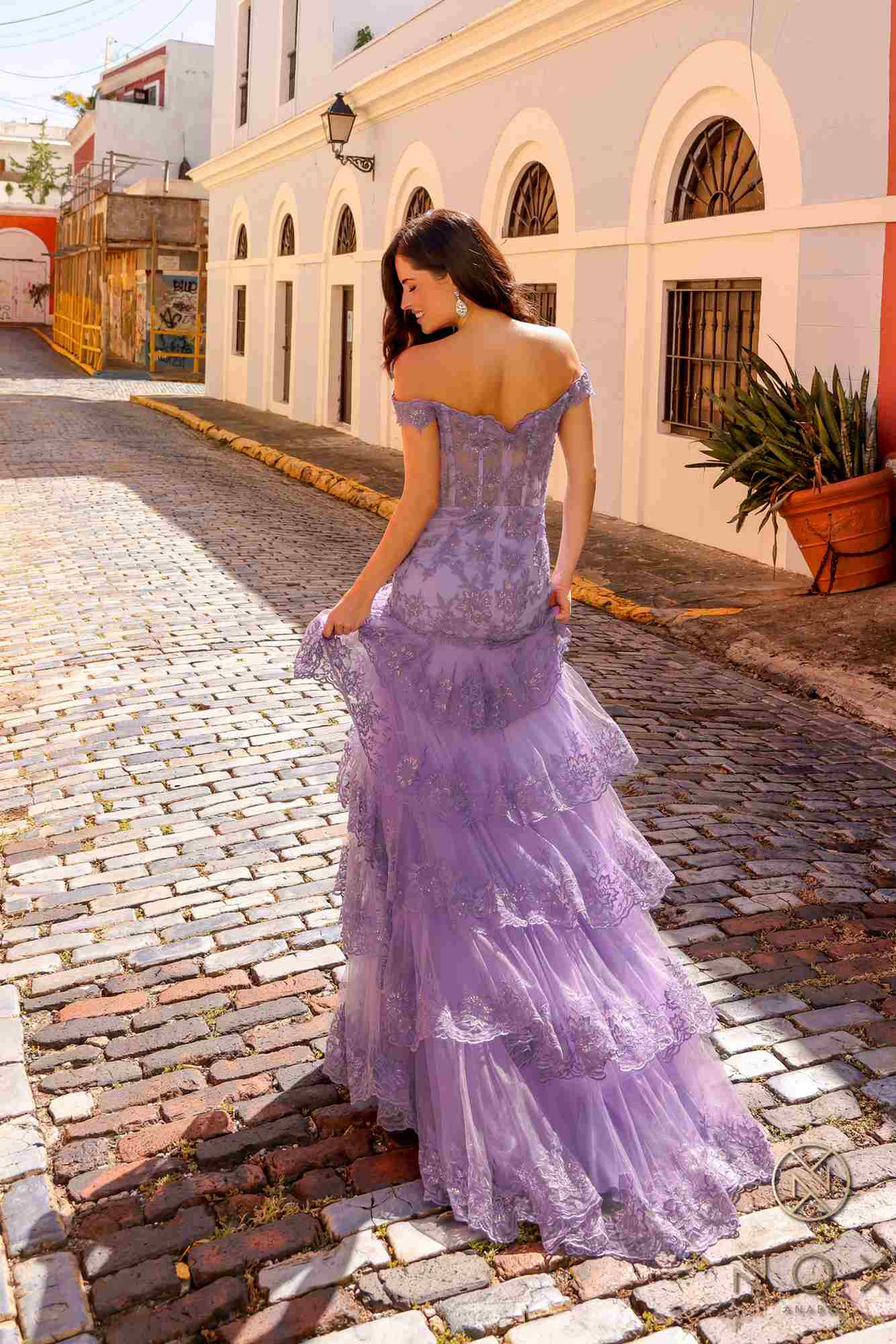 Lilac off-shoulder corset dress with tiered ruffle skirt and thigh slit, side view