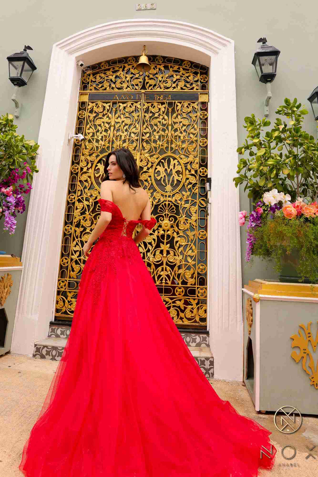 Long off-shoulder sweetheart tulle A-line gown in red, angled back view