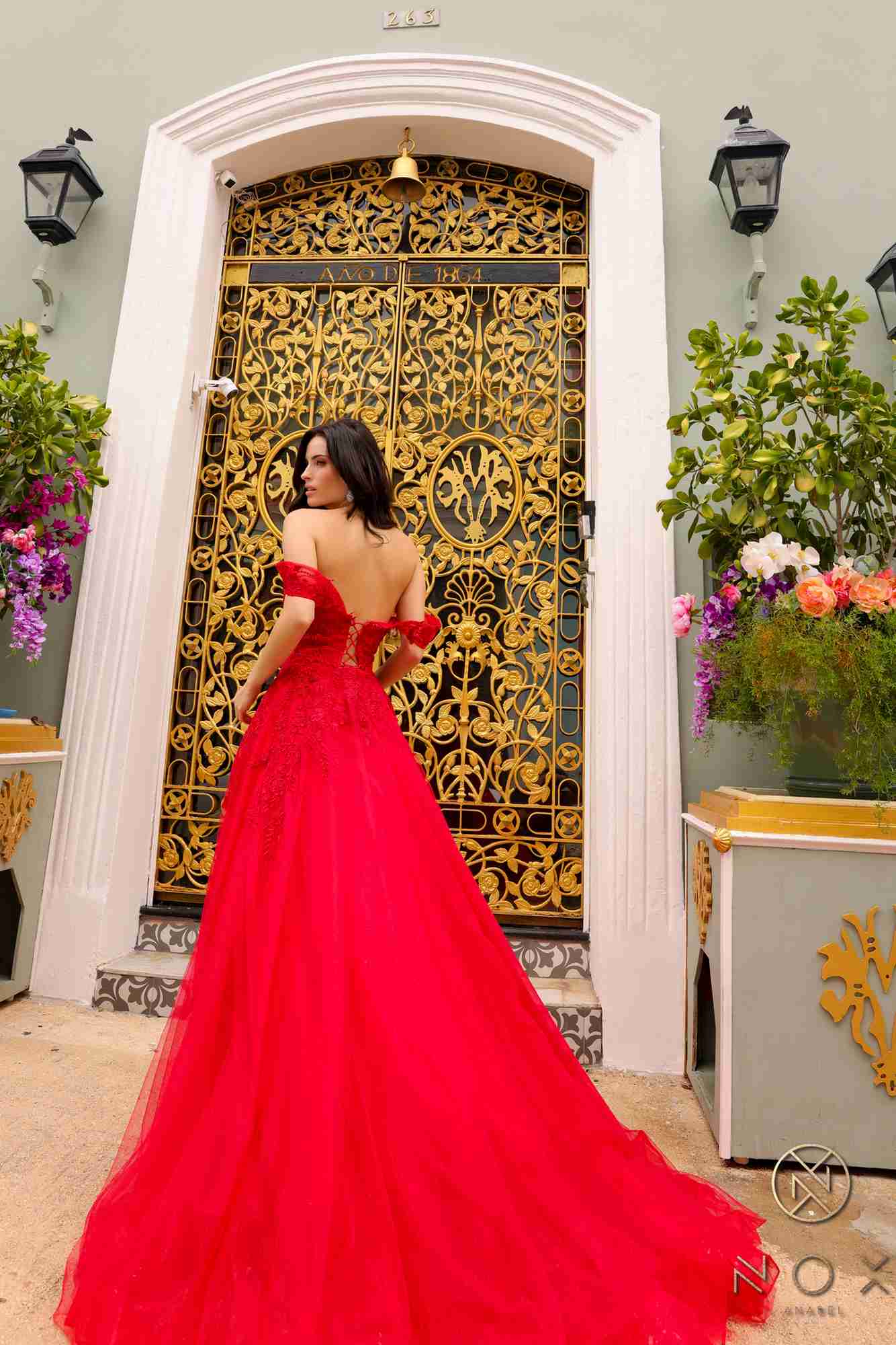 Long off-shoulder sweetheart tulle A-line gown in red, angled back view