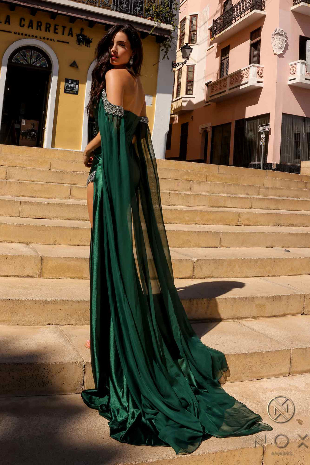 Emerald green fitted satin formal gown with long chiffon cape sleeves, flowing train