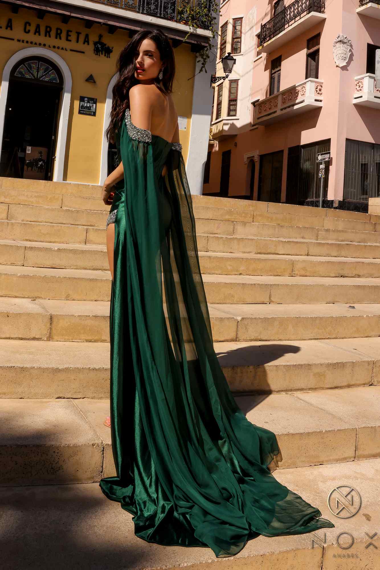 Emerald green fitted satin formal gown with long chiffon cape sleeves, flowing train