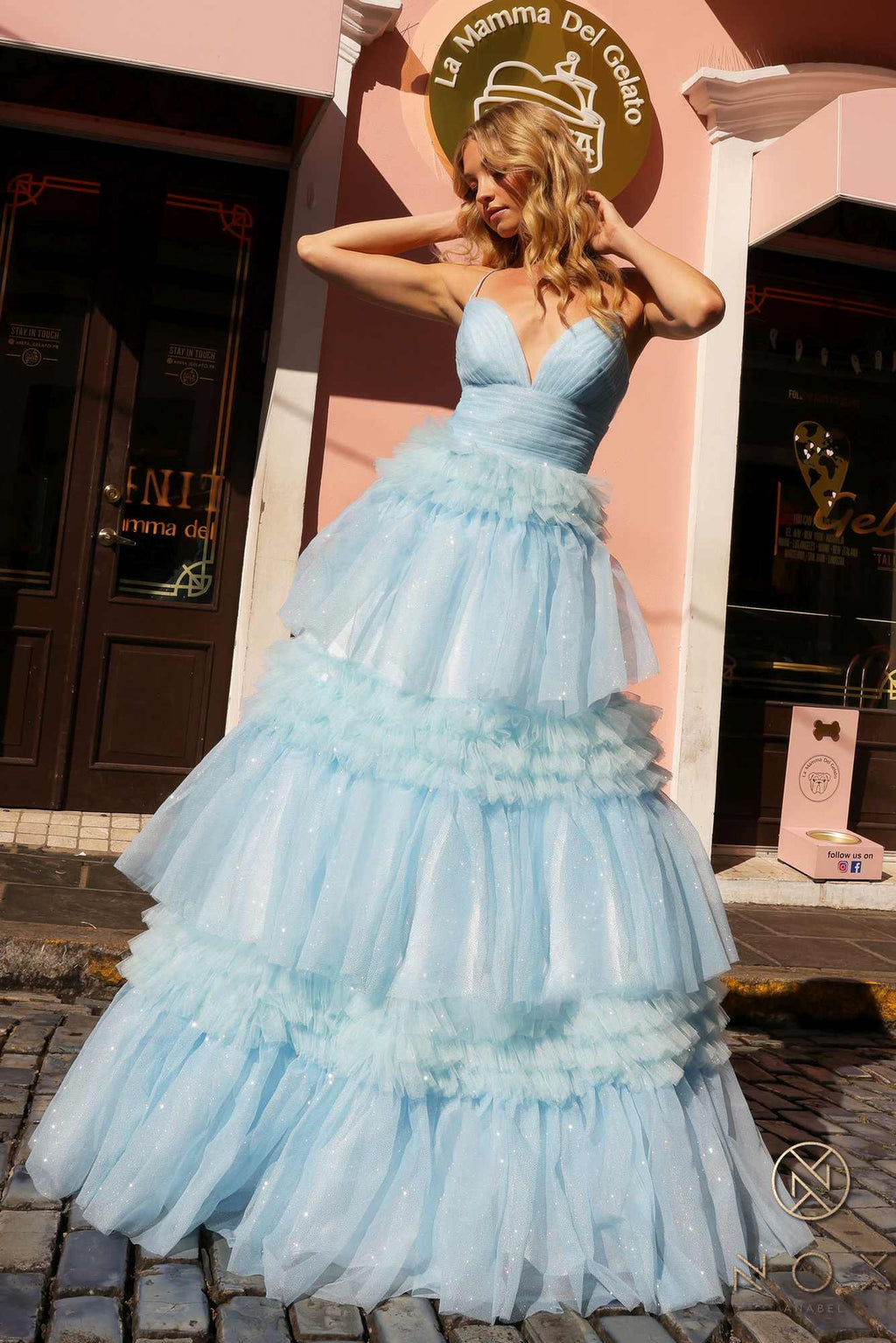 Light blue glitter ruffled tiered A-line gown with V-neck bodice and flared skirt