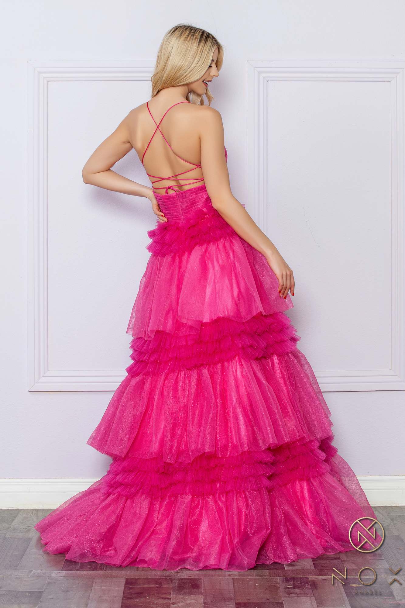 Fuchsia glitter tiered A-line gown with backless straps and layered ruffle skirt