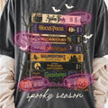 Black spooky season graphic tee with colorful movie poster collage and bats