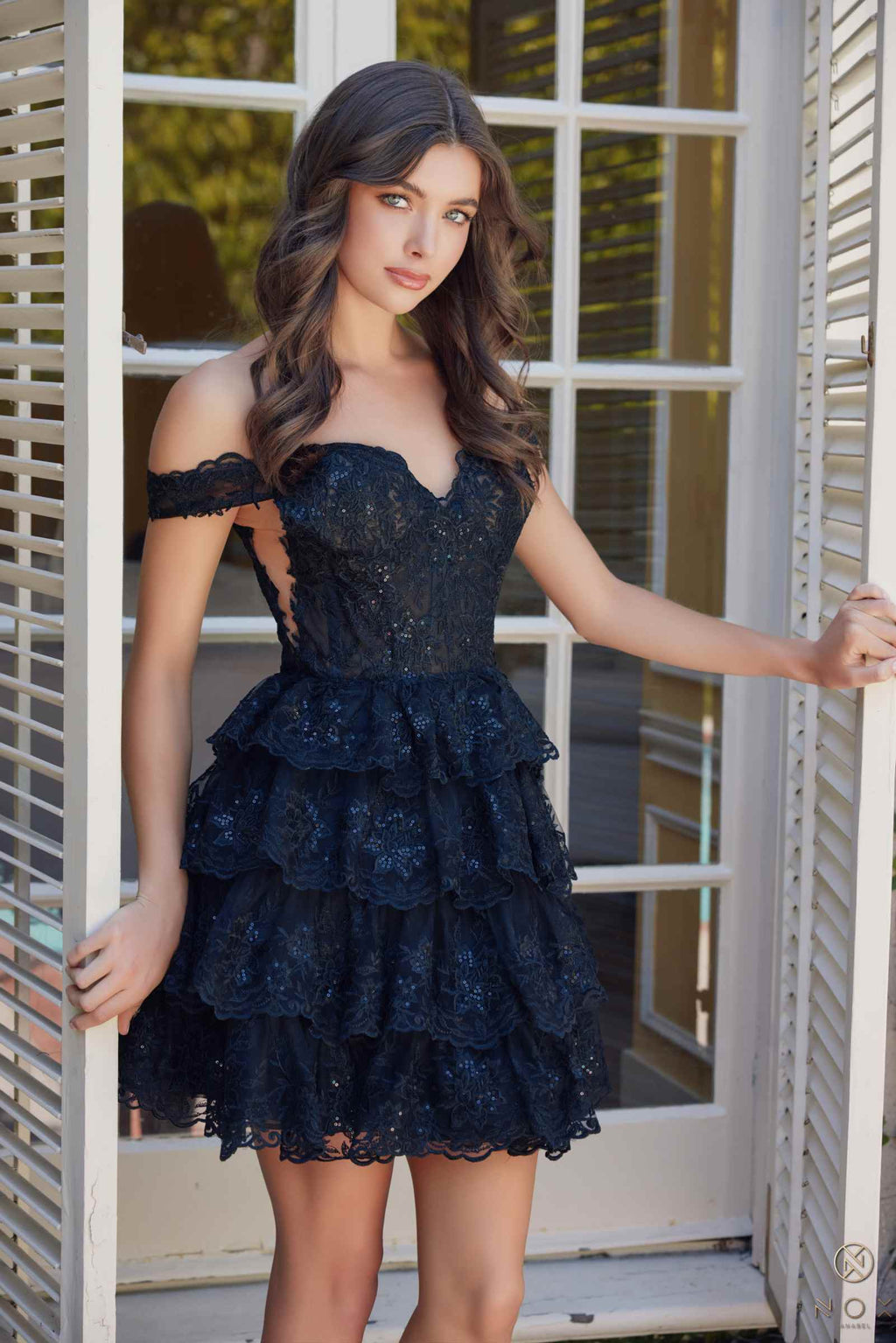 Black off-shoulder tiered lace mini dress with scalloped neckline and layered skirt