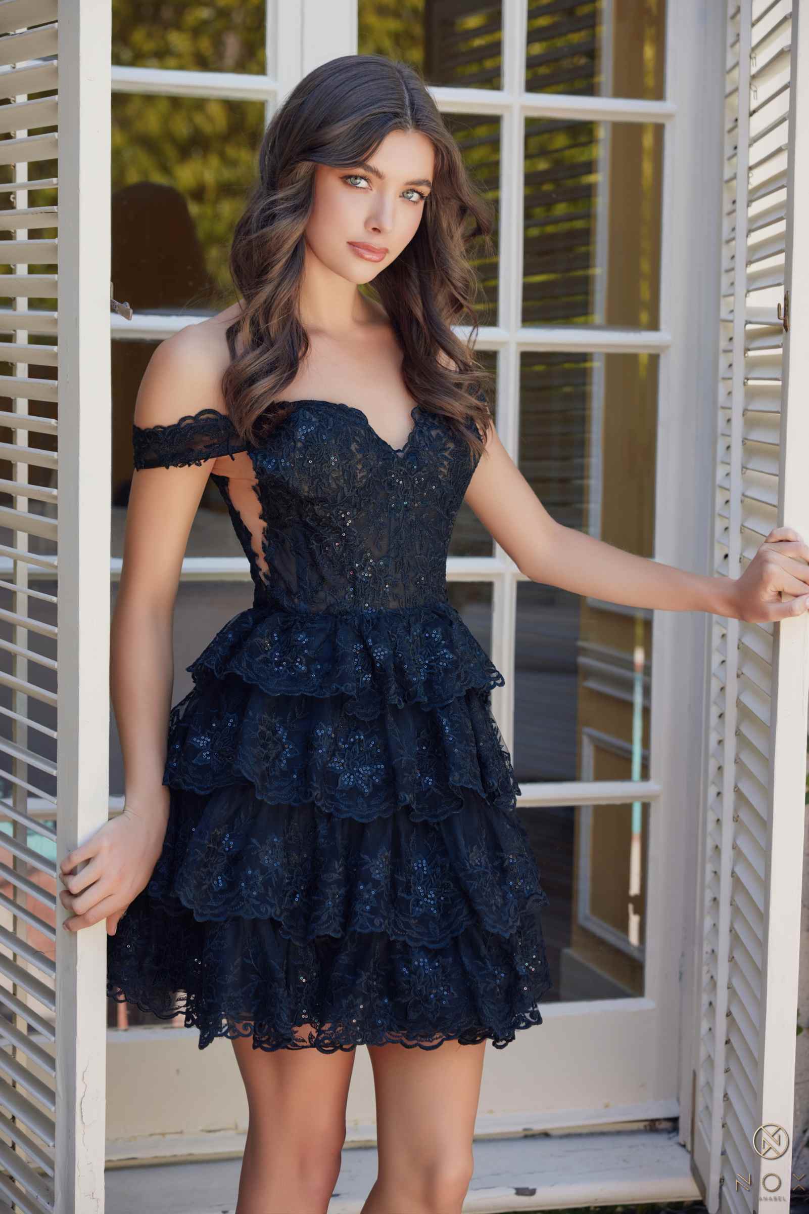 Black off-shoulder tiered lace mini dress with scalloped neckline and layered skirt