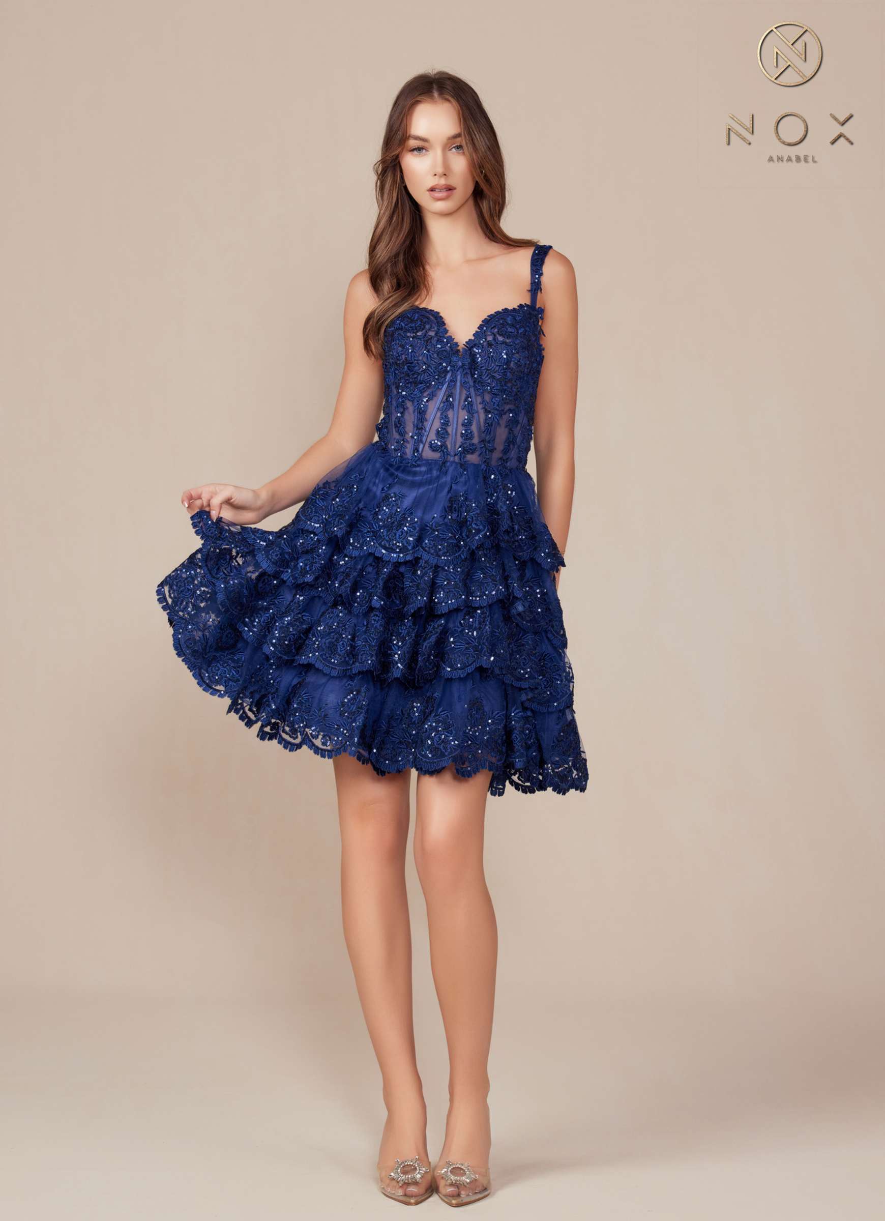 Navy blue sleeveless A-line tiered dress with lace-style embroidery and ruffle skirt