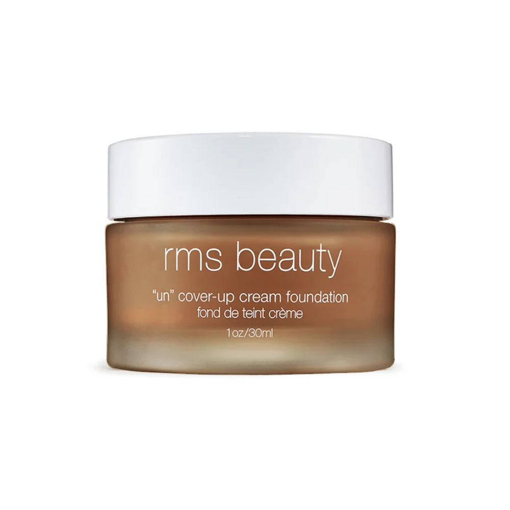 Cream foundation jar with white cap, deep beige cream product inside