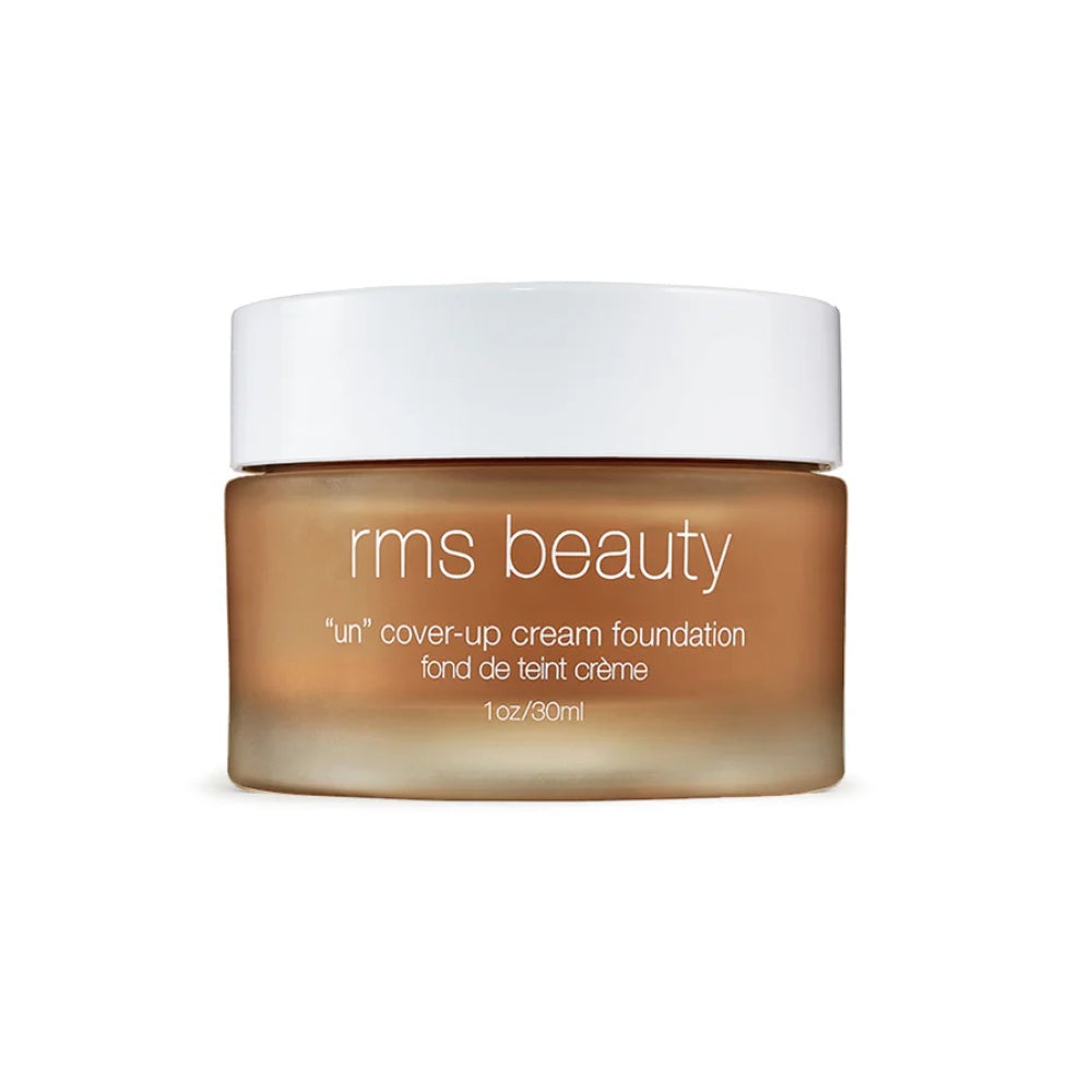 Cream foundation jar with white cap, medium beige cream product inside