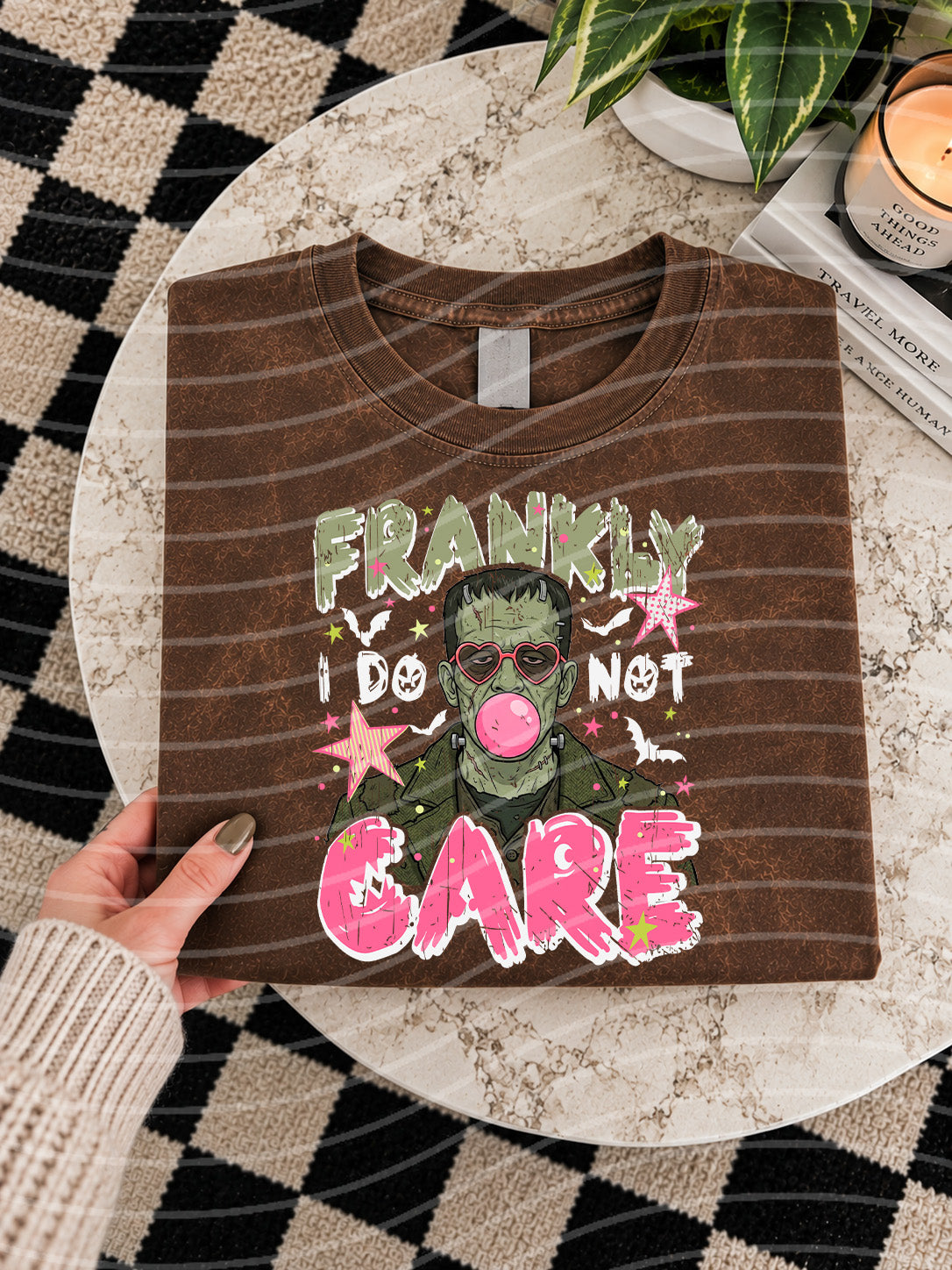 Brown graphic T-shirt with large colorful “Frankly I Do Not Care” print on front