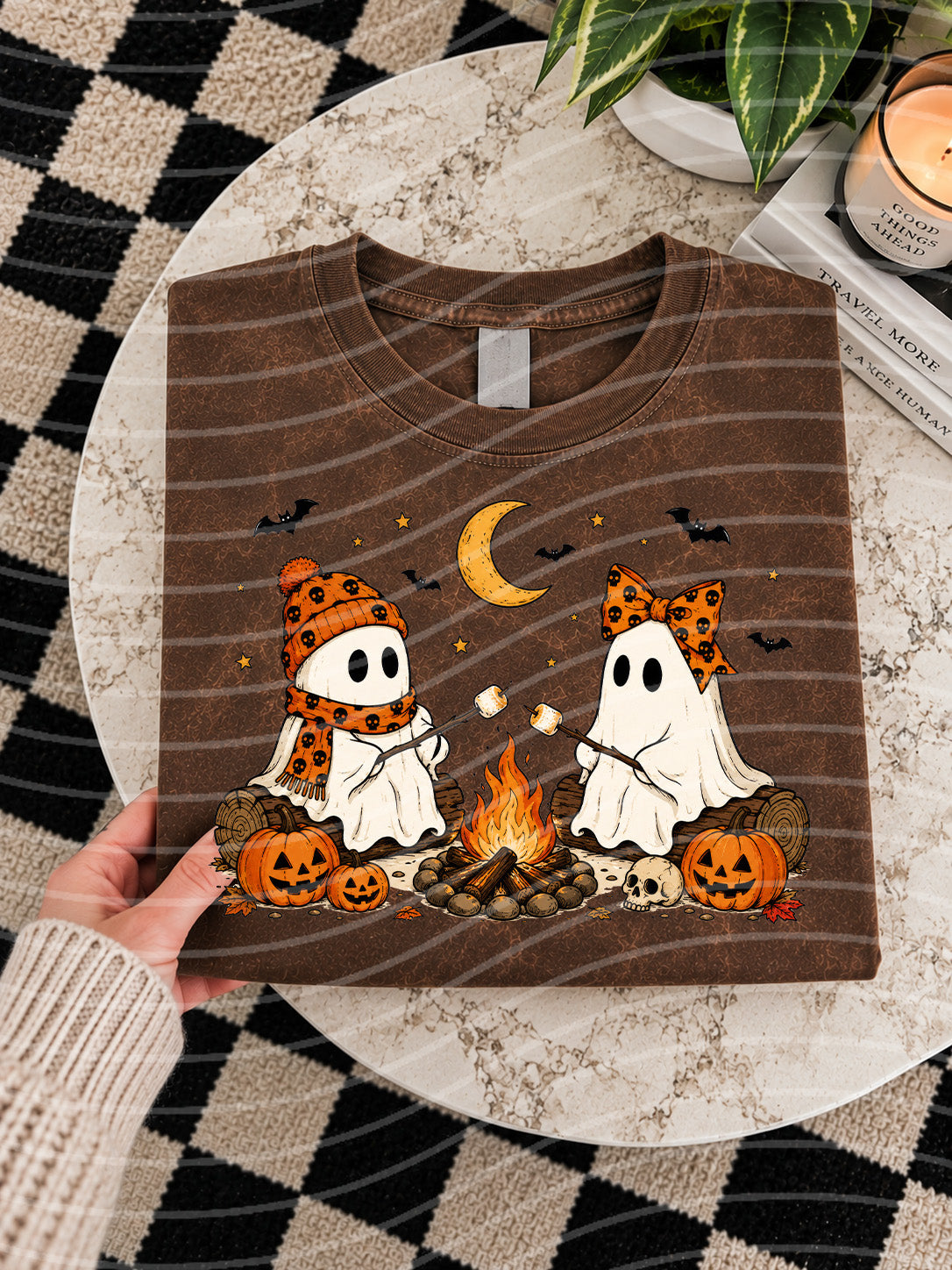 Dark brown graphic tee with smiling ghosts and Halloween pumpkins design
