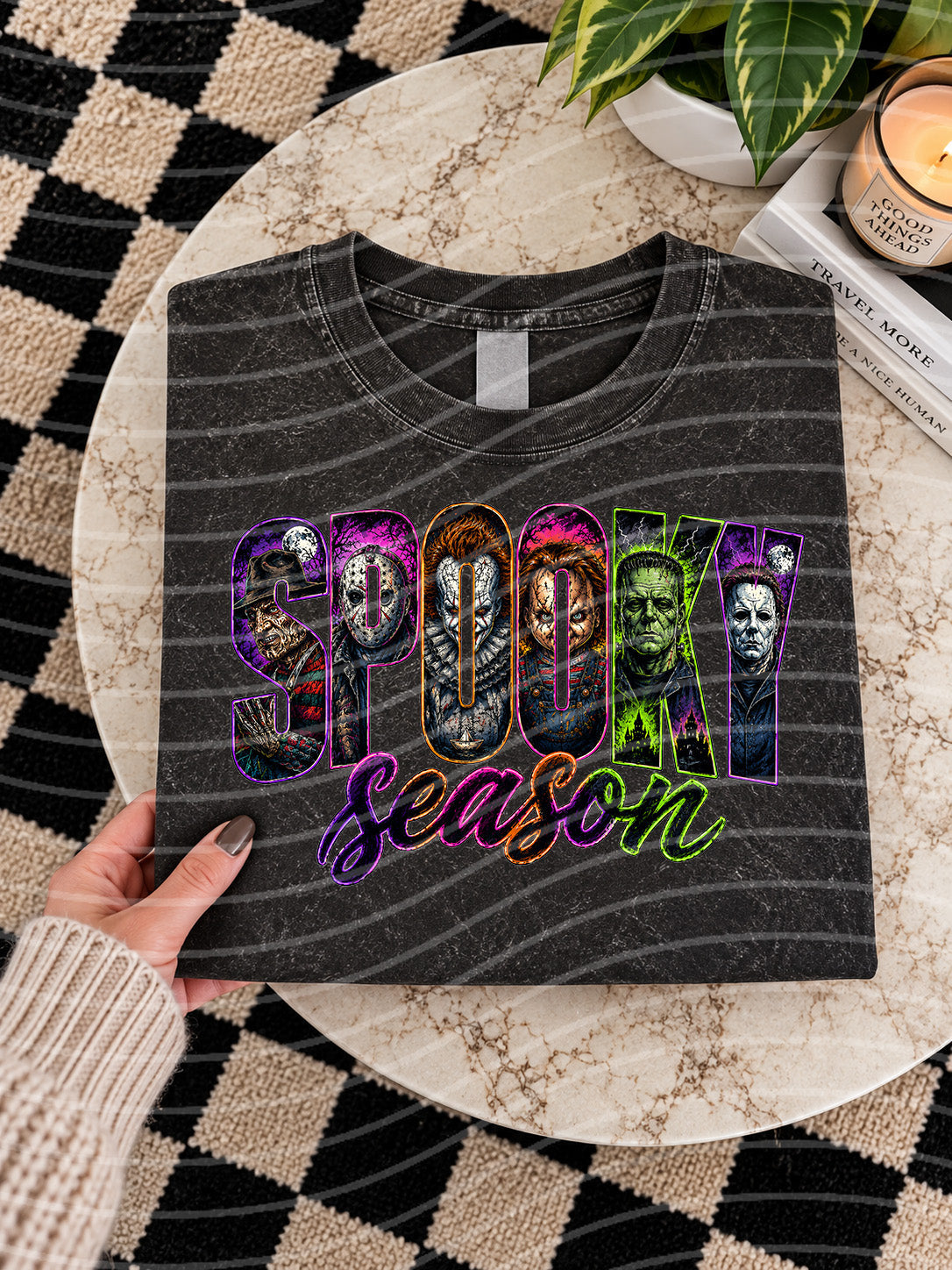 Dark graphic tee with “Spooky Season” lettering and monster face characters
