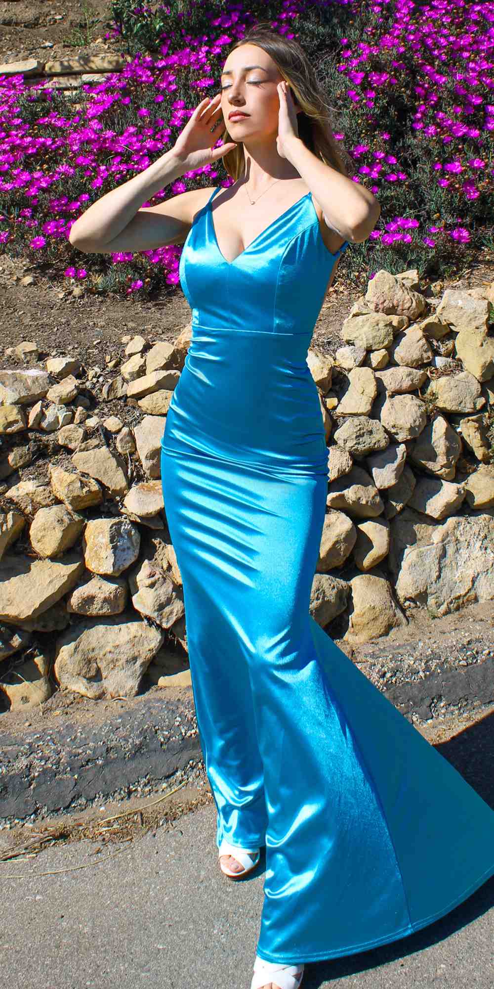 Neon blue fitted long gown with thin straps and flared mermaid skirt
