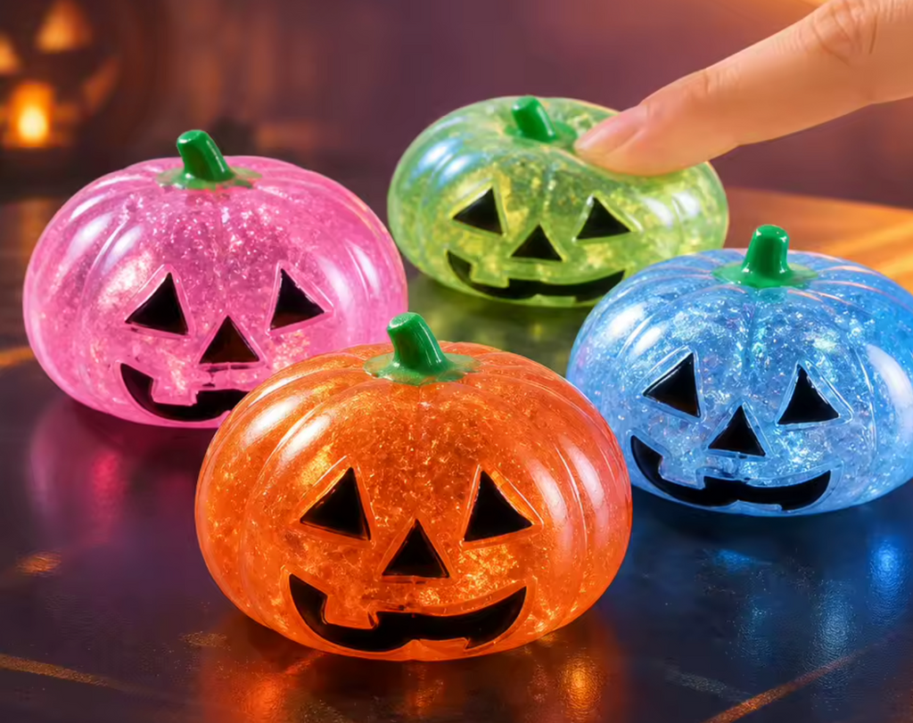 Glittery jack-o’-lantern pumpkin squishies: orange, pink, green, blue, firm rebound
