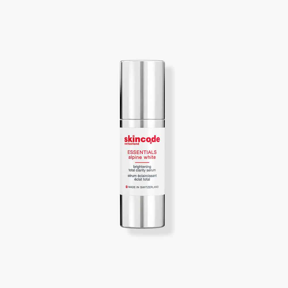 Skincode essentials alpine white brightening serum in silver pump bottle