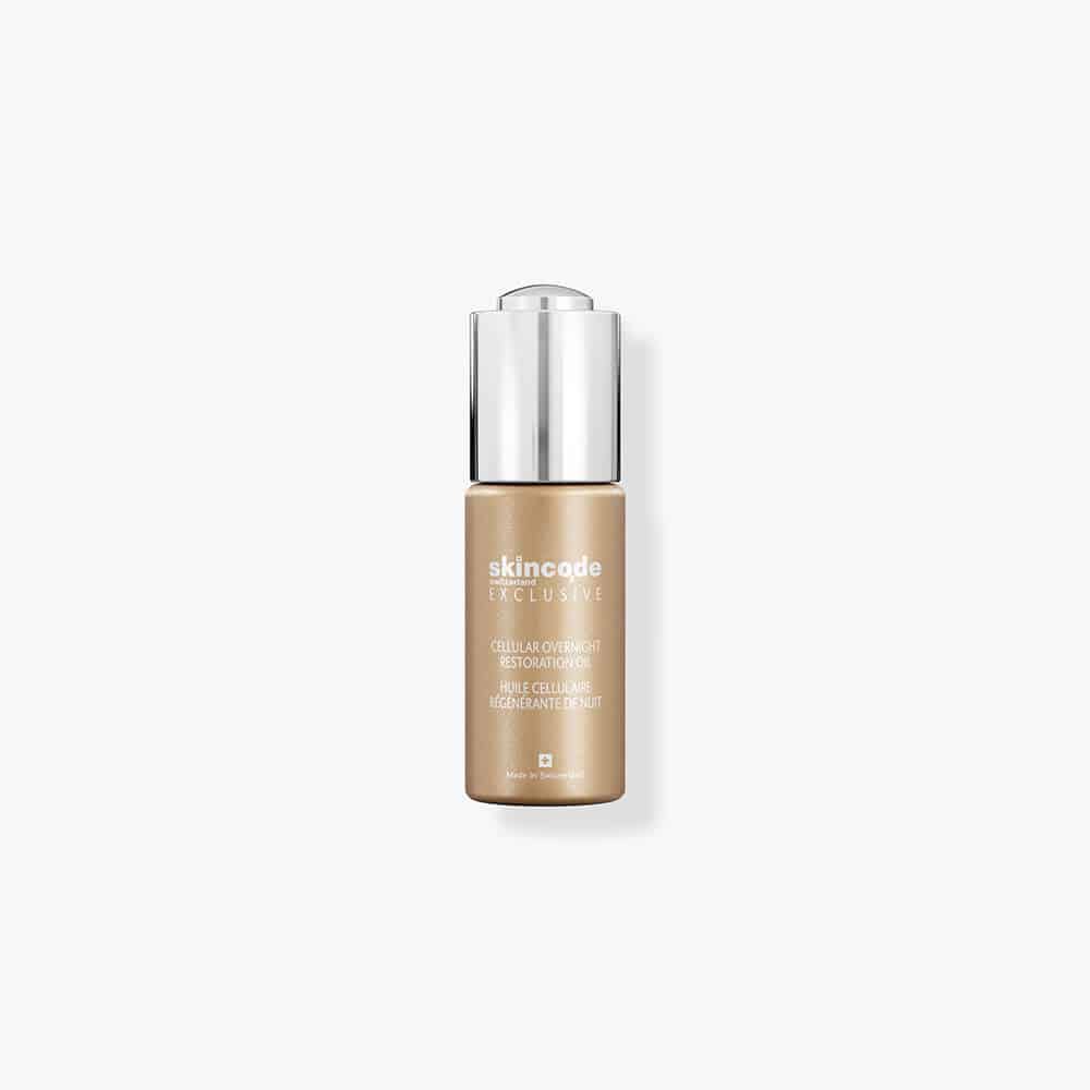 Skincode overnight restoration oil bottle with silver pump cap, amber serum