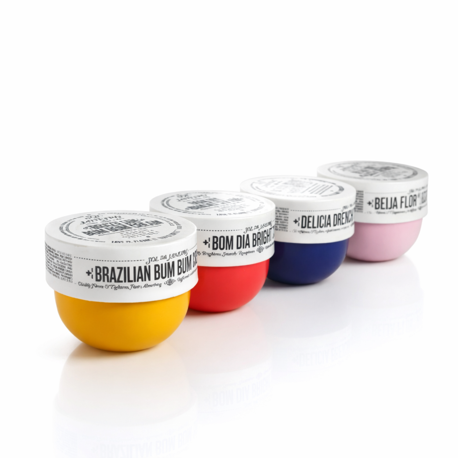 Body cream set with four tubs lined up: yellow, red, blue, and pink.