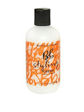 Bumble and Bumble styling creme bottle, black cap, off-white bottle with orange label