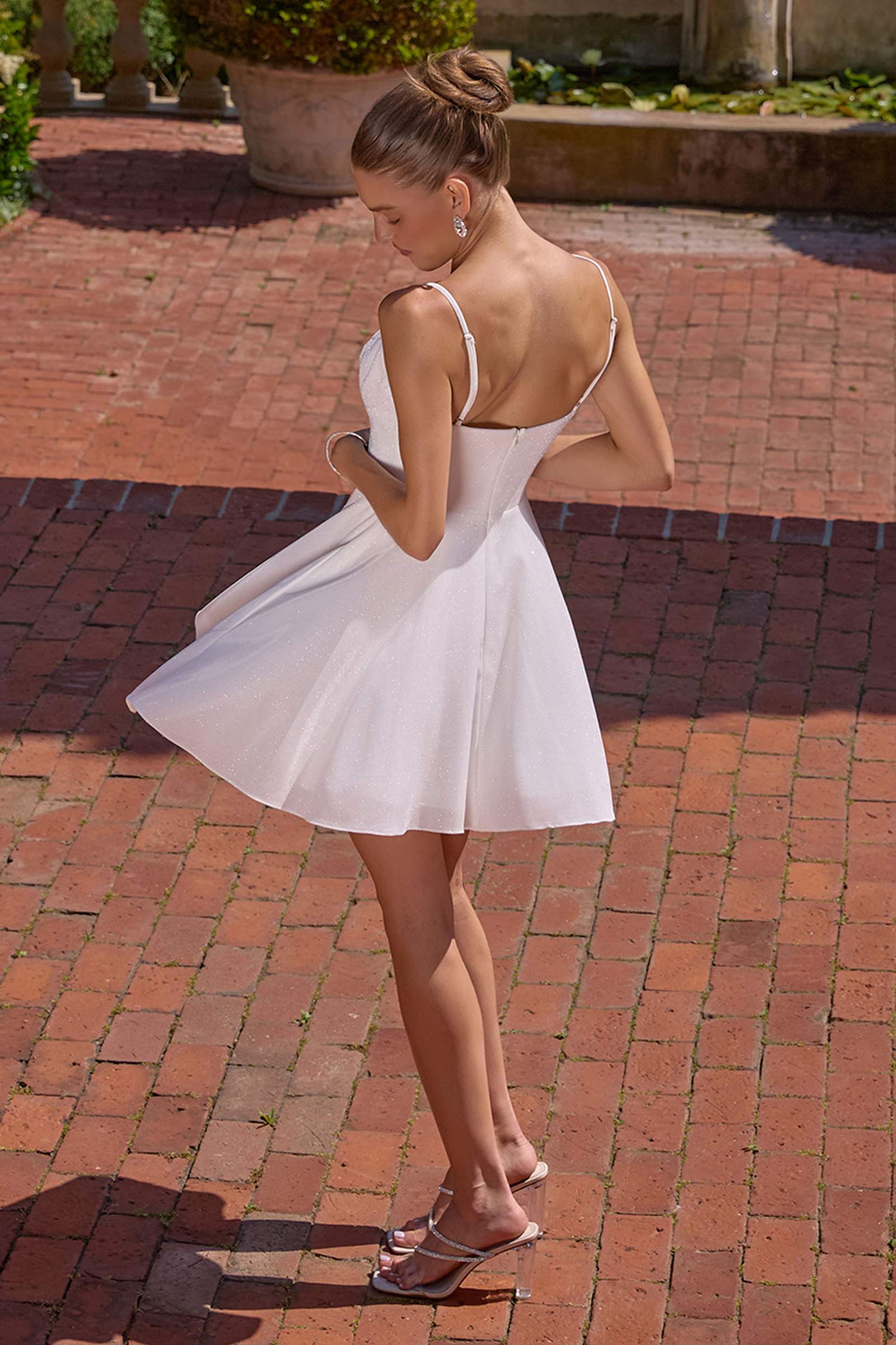 Off-white glitter satin A-line mini dress with low open back and spaghetti straps