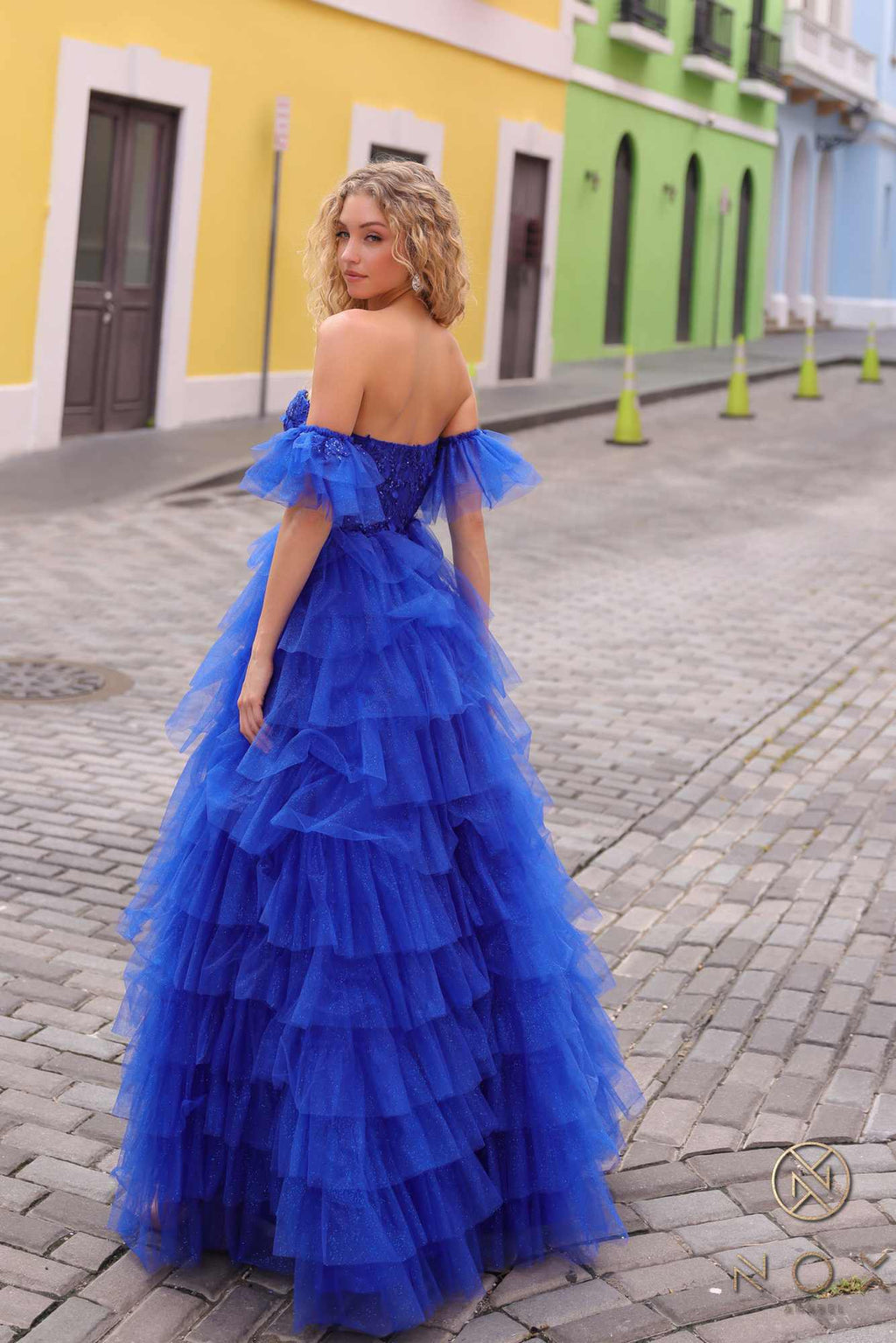 Royal blue long ruffled tiered A-line ball gown with off-shoulder bodice and arm cuffs