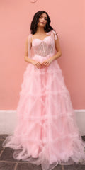 Blush pink long A-line gown with boned corset bodice, ribbon straps, layered ruffles