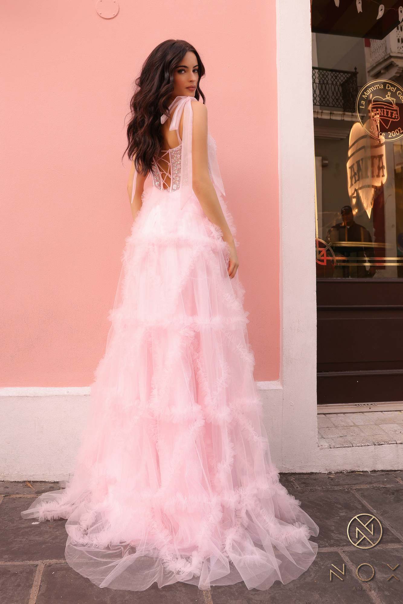 Blush pink long gown with ribbon straps and fluffy tiered ruffle skirt