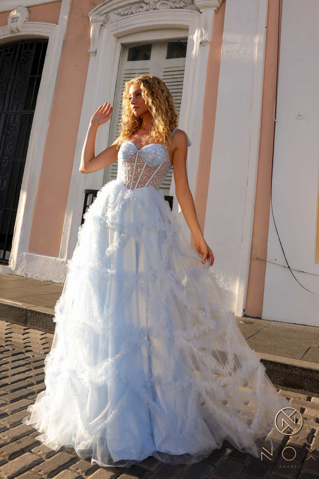 Light blue ruffled tulle A-line gown with corset bodice and spaghetti straps