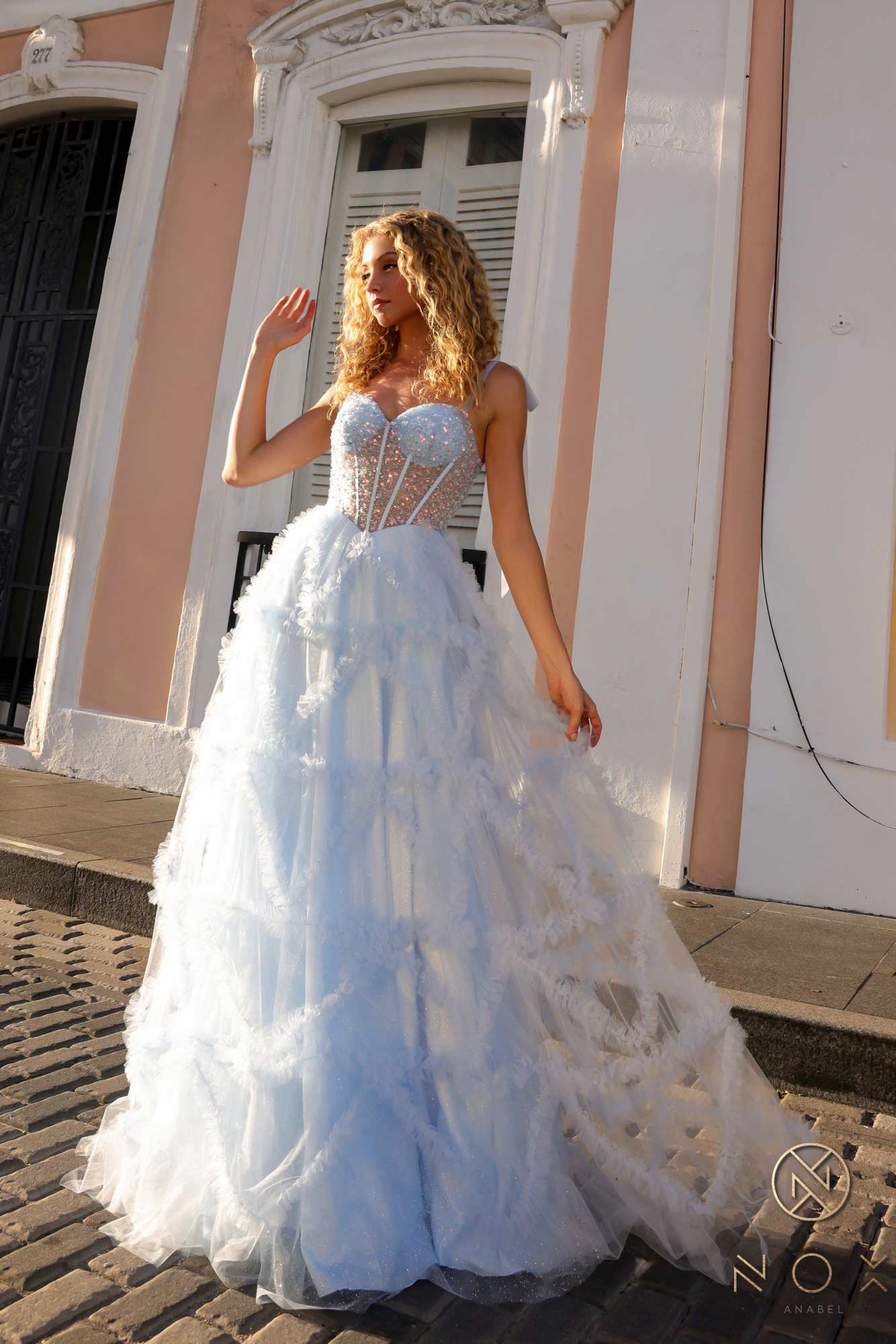 Light blue ruffled tulle A-line gown with corset bodice and spaghetti straps