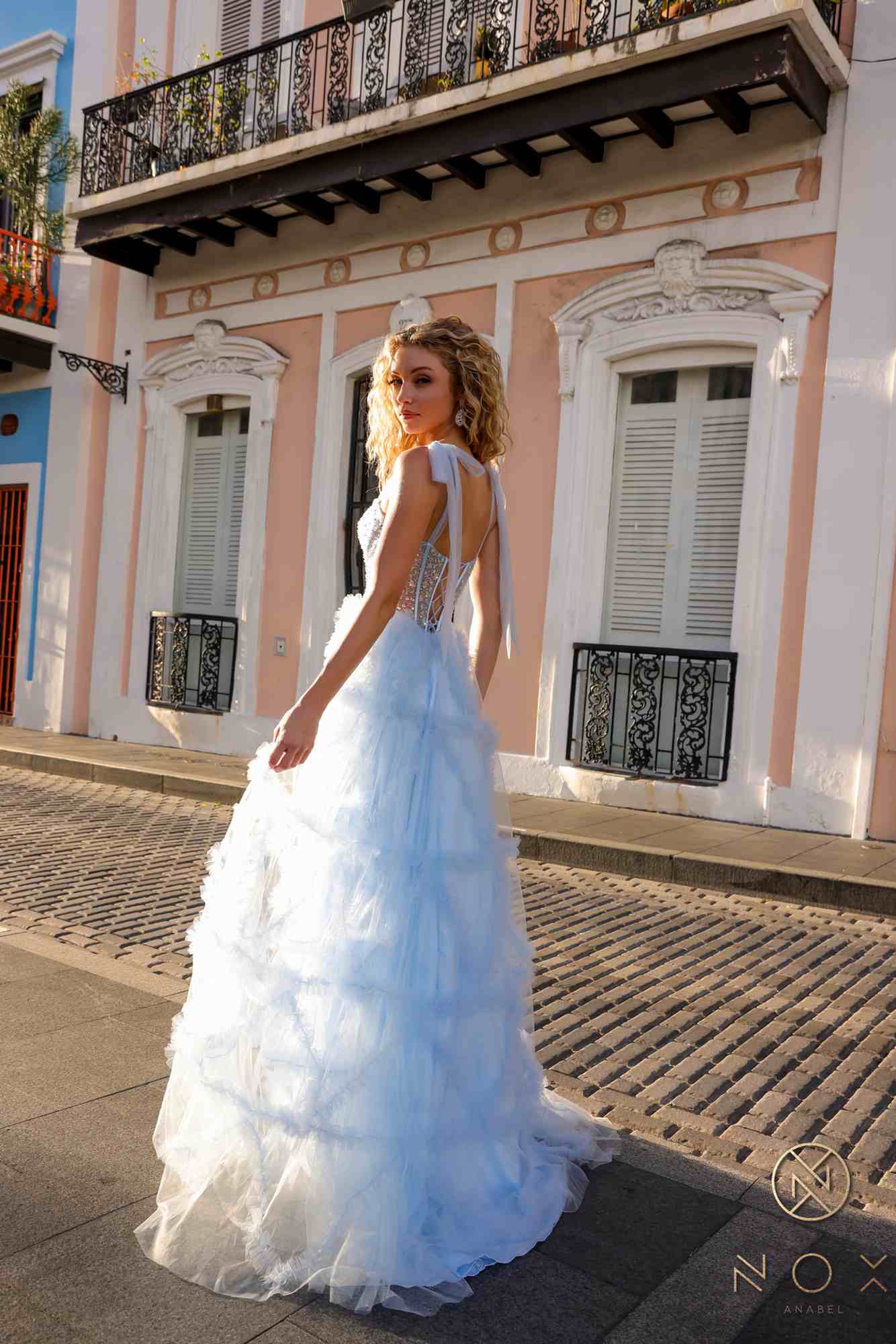 Light blue ruffled tulle ballgown with corset-style bodice and spaghetti straps