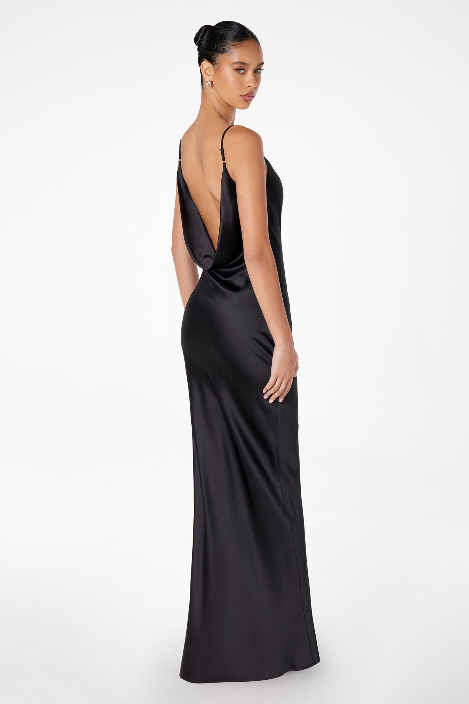 Sleeveless open-back satin gown in dark black, low back and long column silhouette.