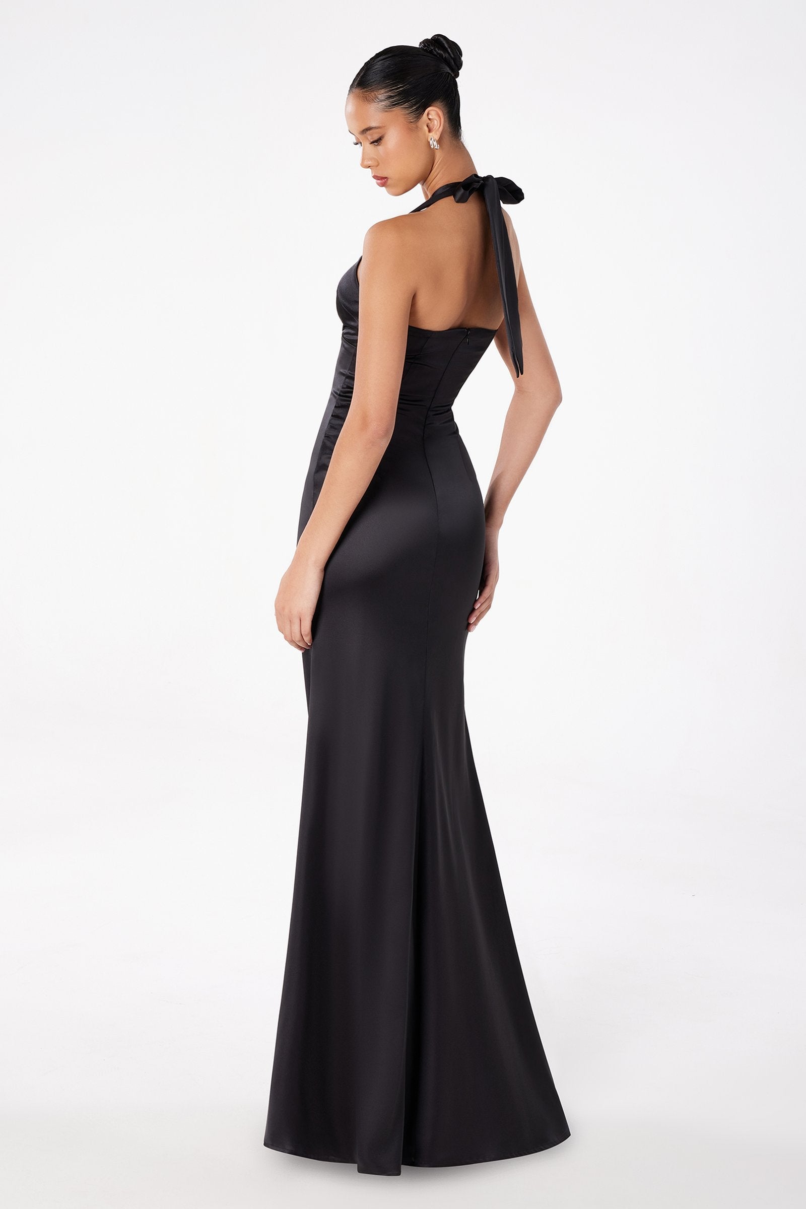 Black halter evening gown with open back, fitted waist, and long skirt