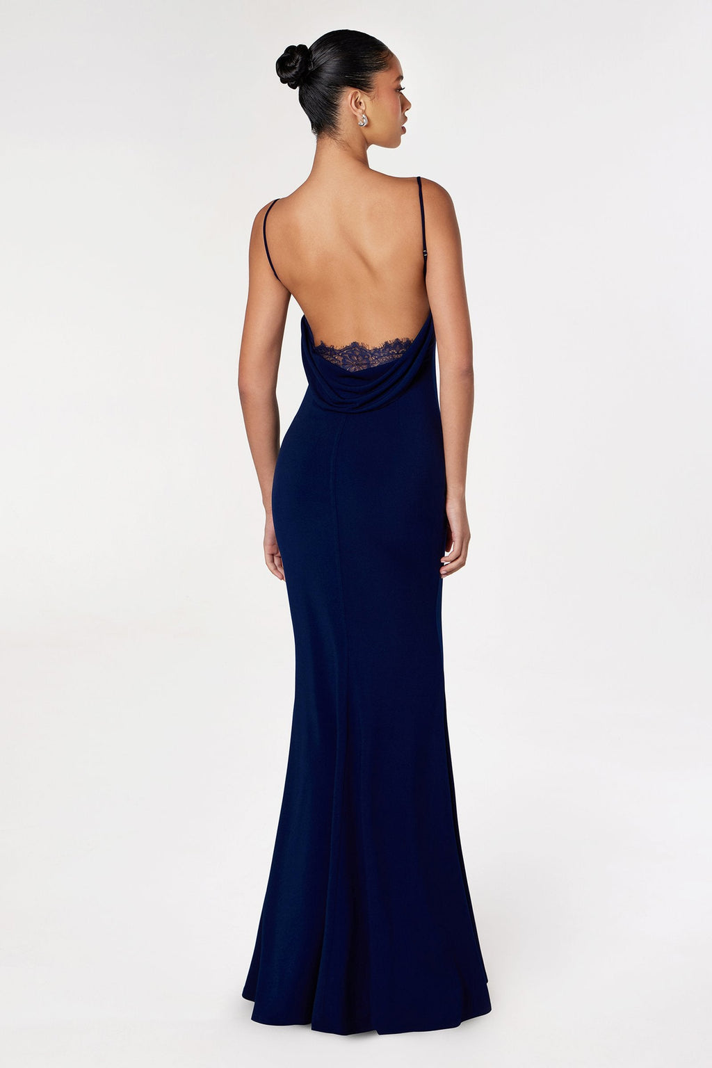 Navy blue fitted spaghetti-strap gown with lace detail at open back, full length