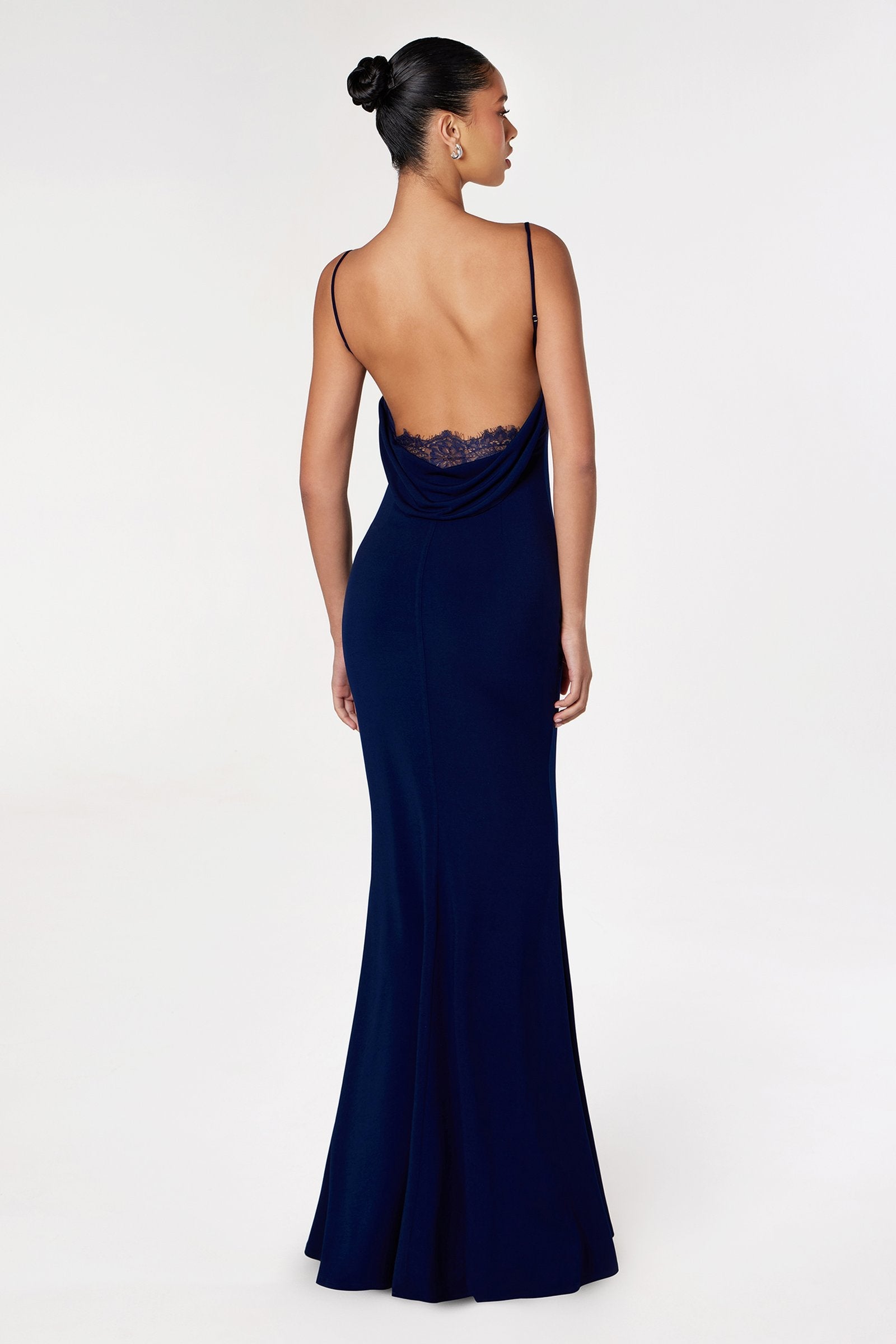Navy blue fitted spaghetti-strap gown with lace detail at open back, full length