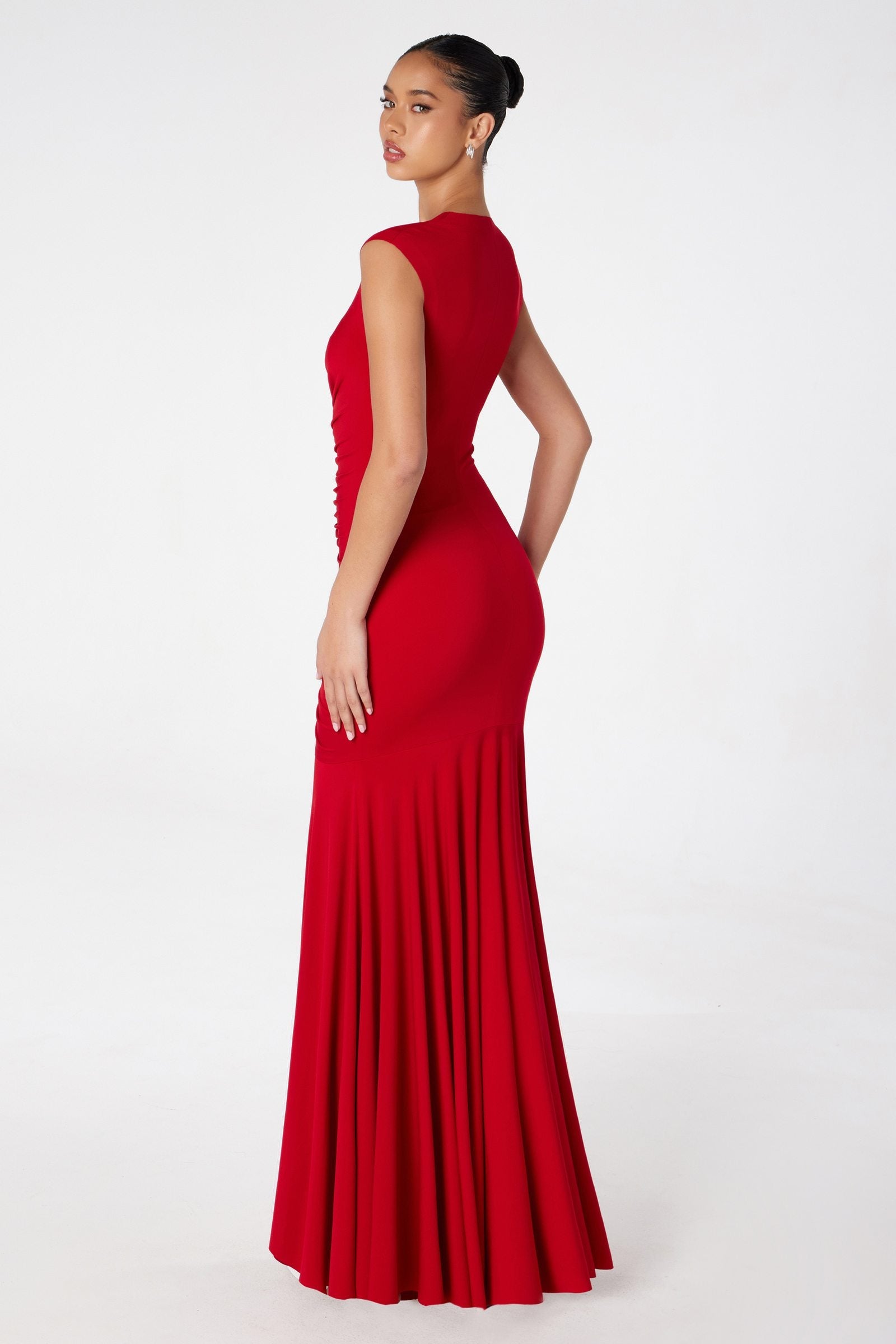 Red long ruched mermaid gown, sleeveless V-neck, profile view