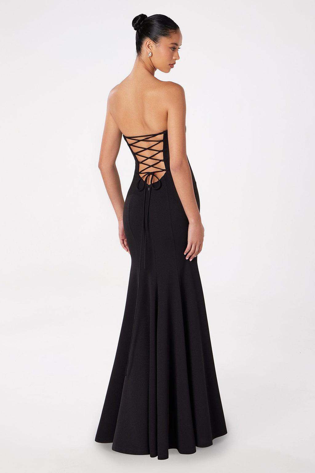 Black strapless mermaid gown with lace-up crisscross back and long fitted skirt.