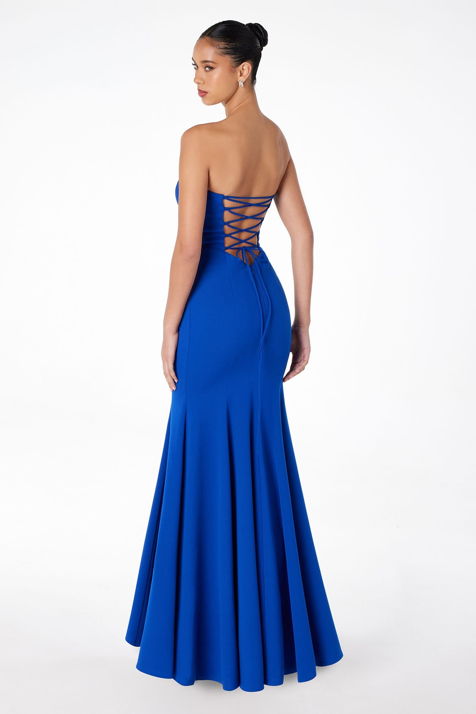Royal blue strapless mermaid gown with lace-up back and pleated skirt.