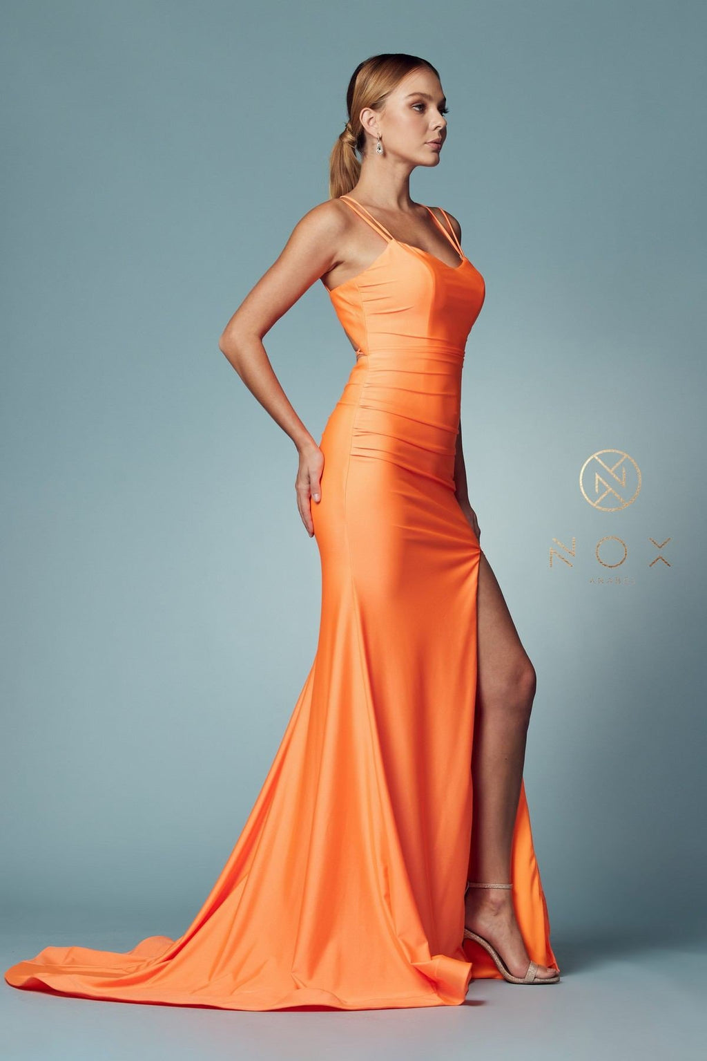 Orange fitted gown with scoop neck, spaghetti straps, side slit, long mermaid hem