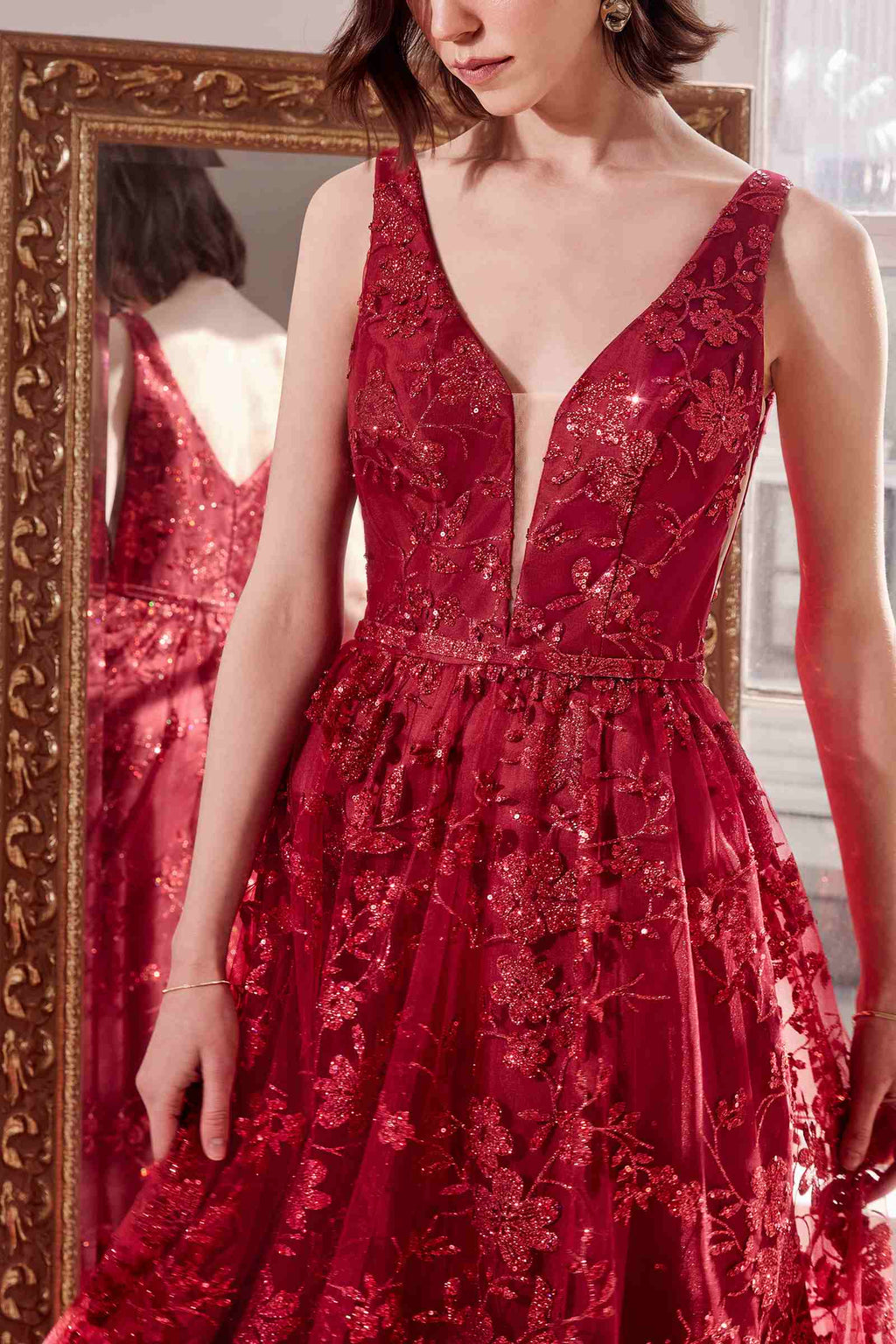 Burgundy long A-line gown, sleeveless V-neck with glittery floral print and gathered skirt.