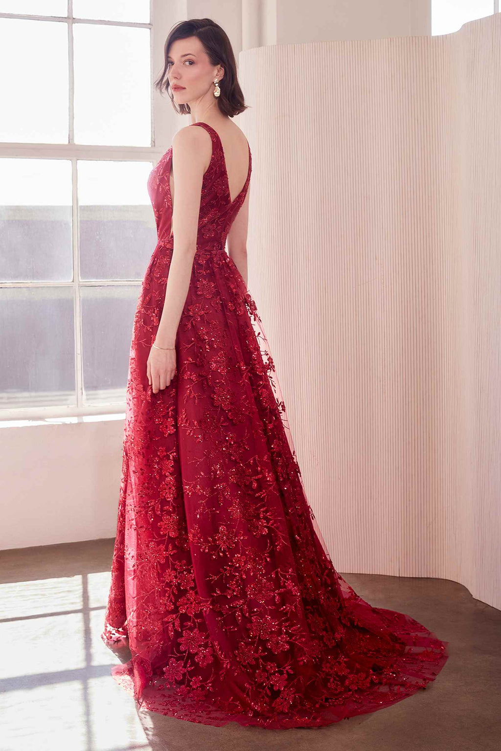Red burgundy long A-line gown, sleeveless V-neck with all-over glitter floral pattern.