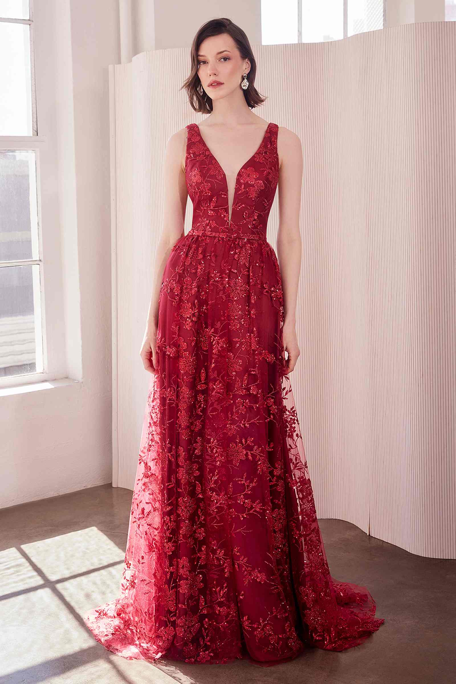 Burgundy long A-line gown, sleeveless V-neck with glittery floral pattern and full skirt.
