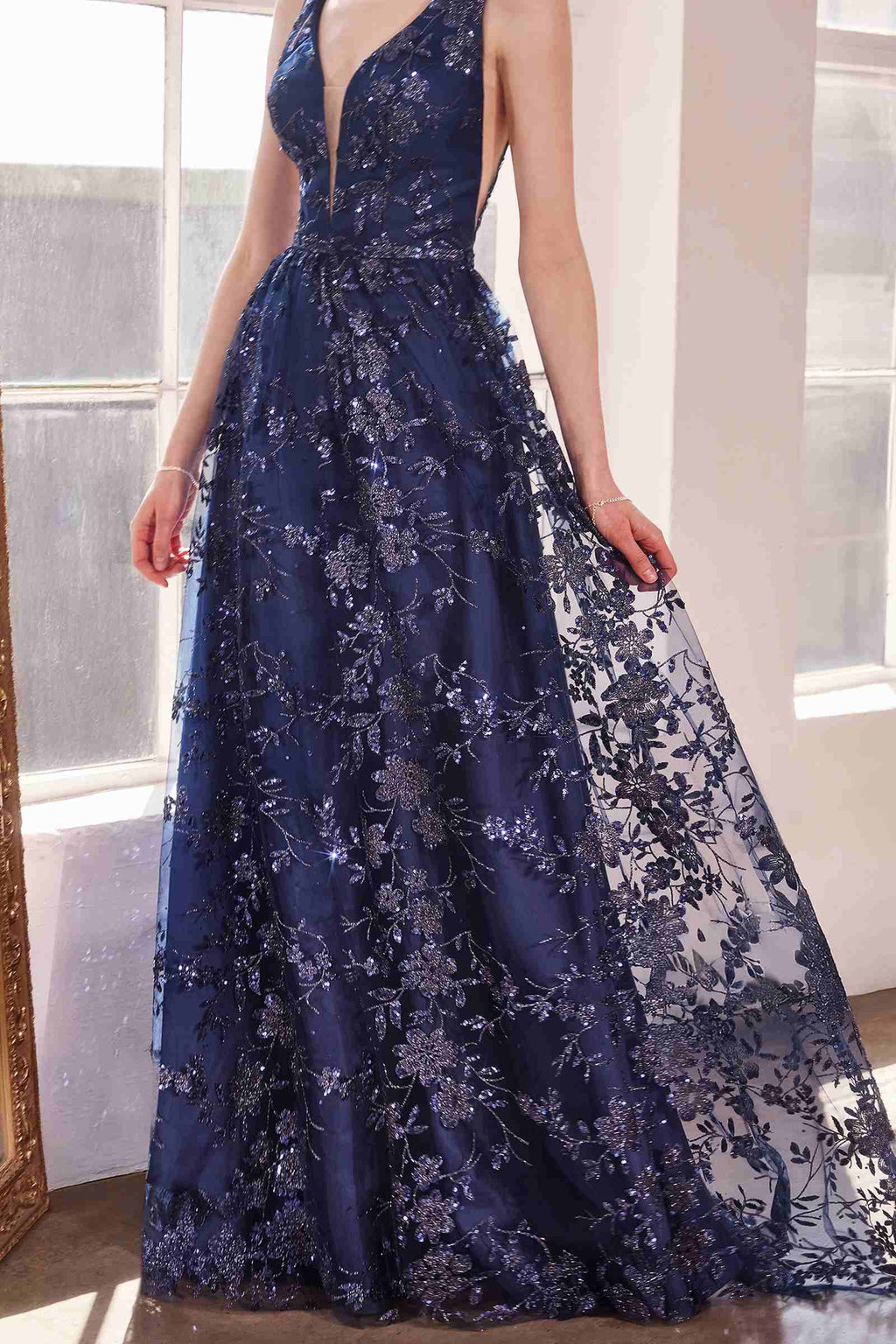 Navy long A-line gown, sleeveless V-neck with all-over glitter floral lace pattern.